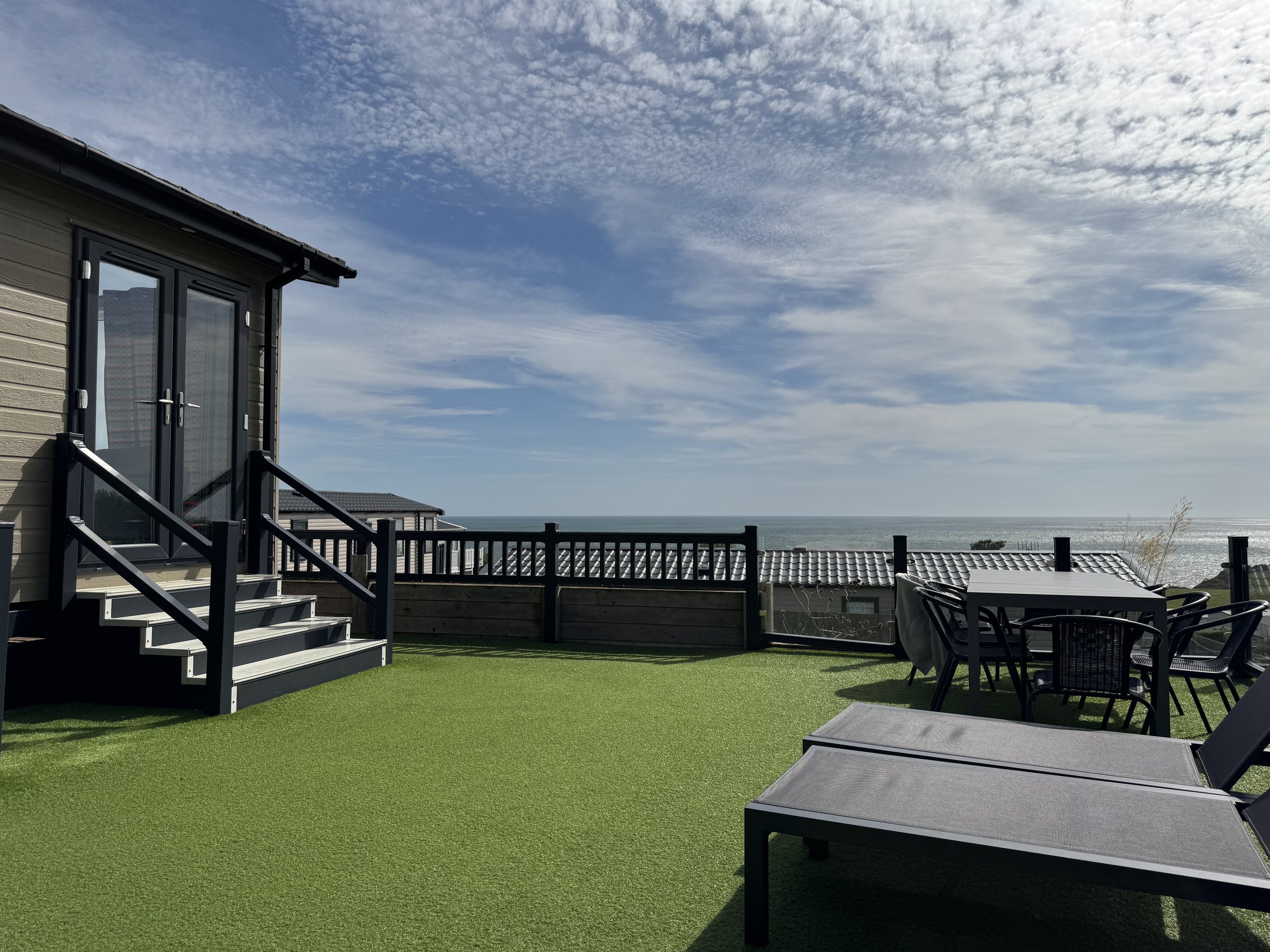 Outdoor seating area at Rockpool Lodge with sea views at Ladram Bay Holiday Park in East Devon