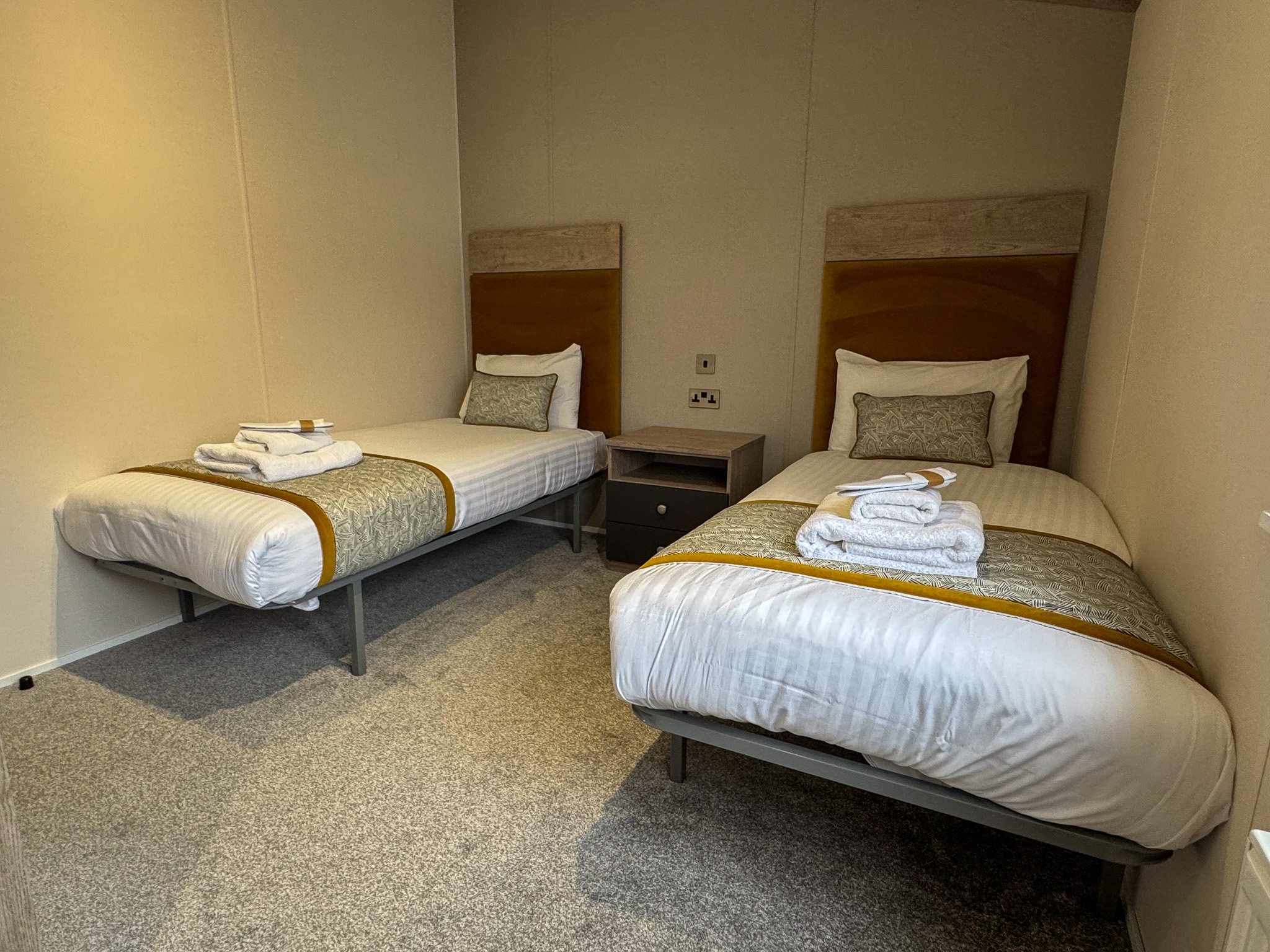 Twin bedroom inside a two-bedroom Platinum Lodge at Bodmin Holiday Park in Cornwall.