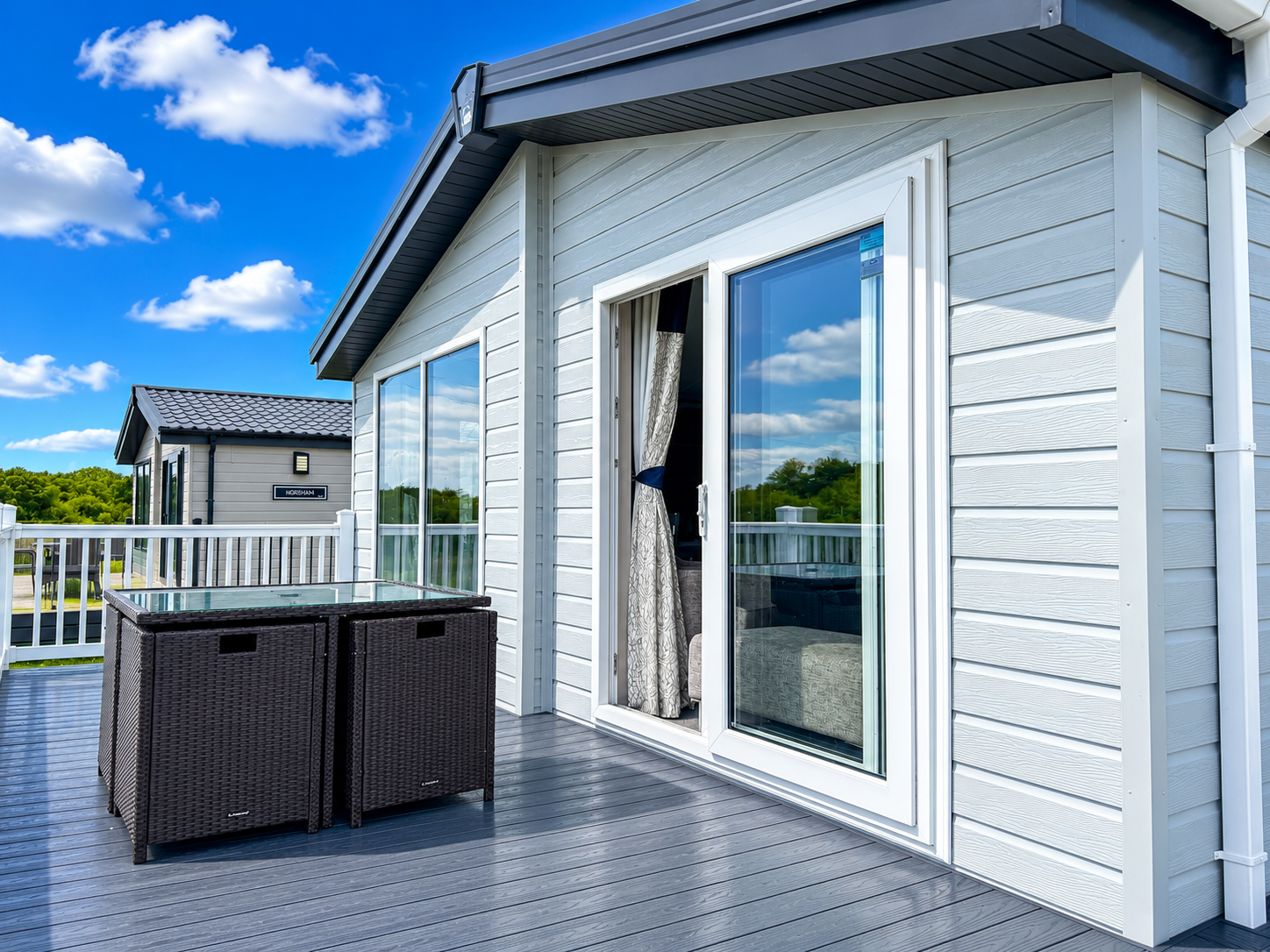 Private decking outside a two-bedroom Platinum Lodge at Bodmin Holiday Park in Cornwall.