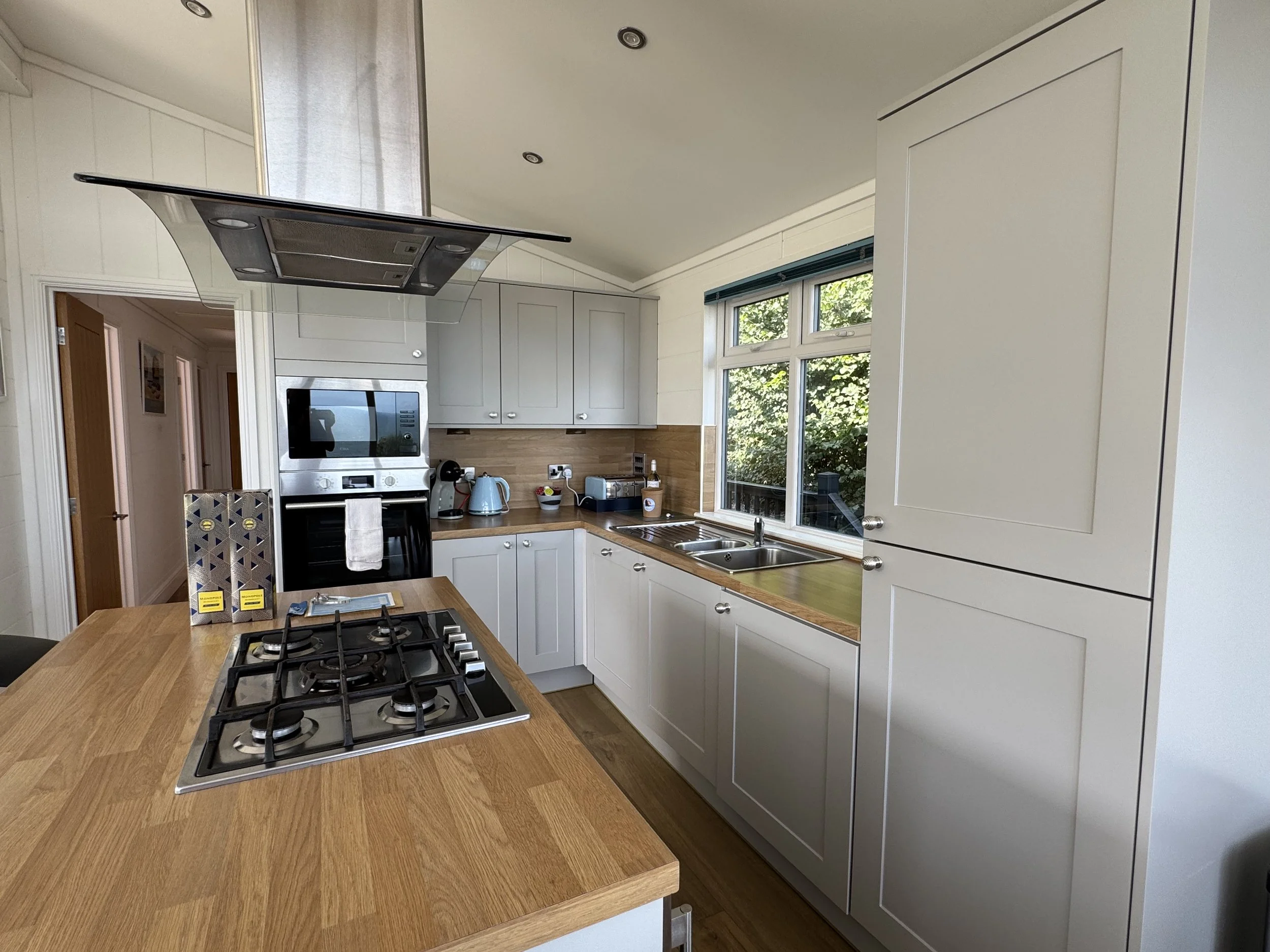 Kitchen inside Rockpool Lodge at Ladram Bay Holiday Park featuring island unit and self-catering facilities