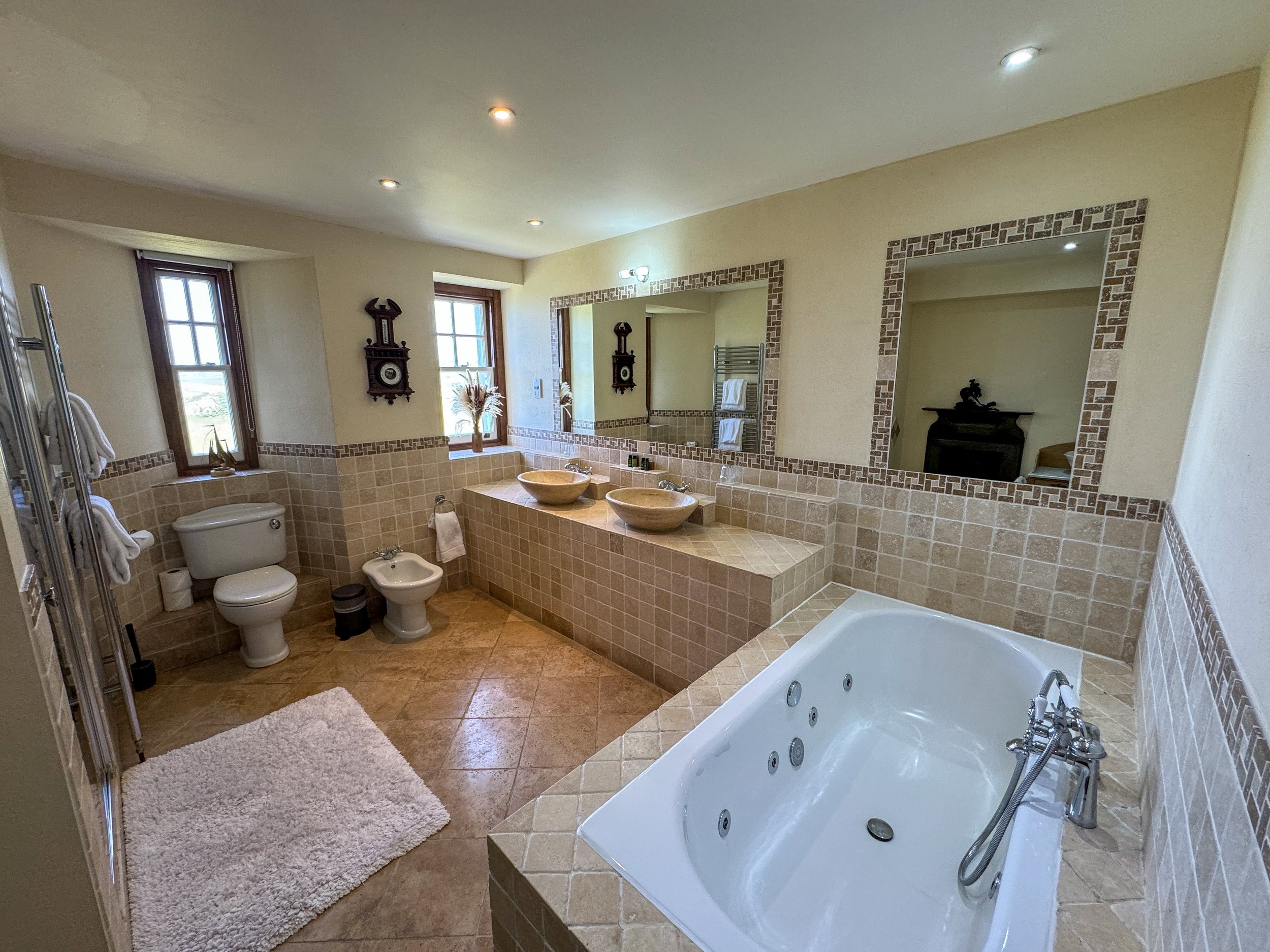 Bathroom with sunken jet bath in the East Tower Junior Suite at Camelot Castle Hotel Tintagel