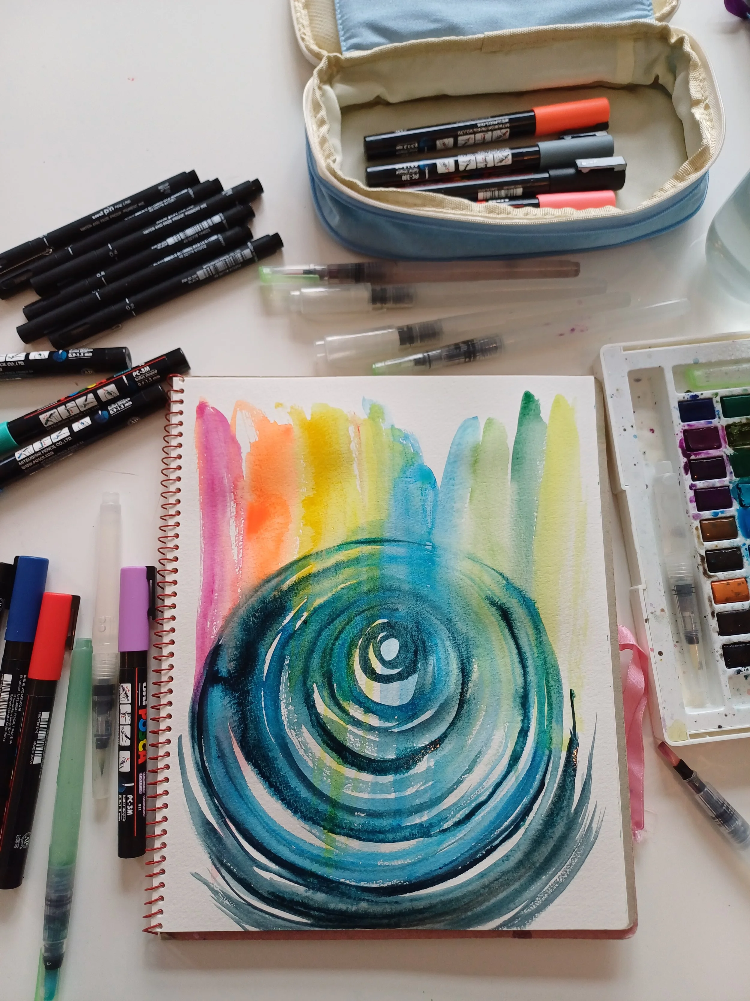 Mixed media artwork on a collage background depicting a green frog with orange and yellow markings, perched on a leafy branch with blue and green leaves, alongside a excerpt from text that reads 'She believe there is a spirit coming from some power or source that runs through all of us. In some strange way that she do not question, she's been able to tap into that source. This is what has enabled her always to say 'I can and I will'.