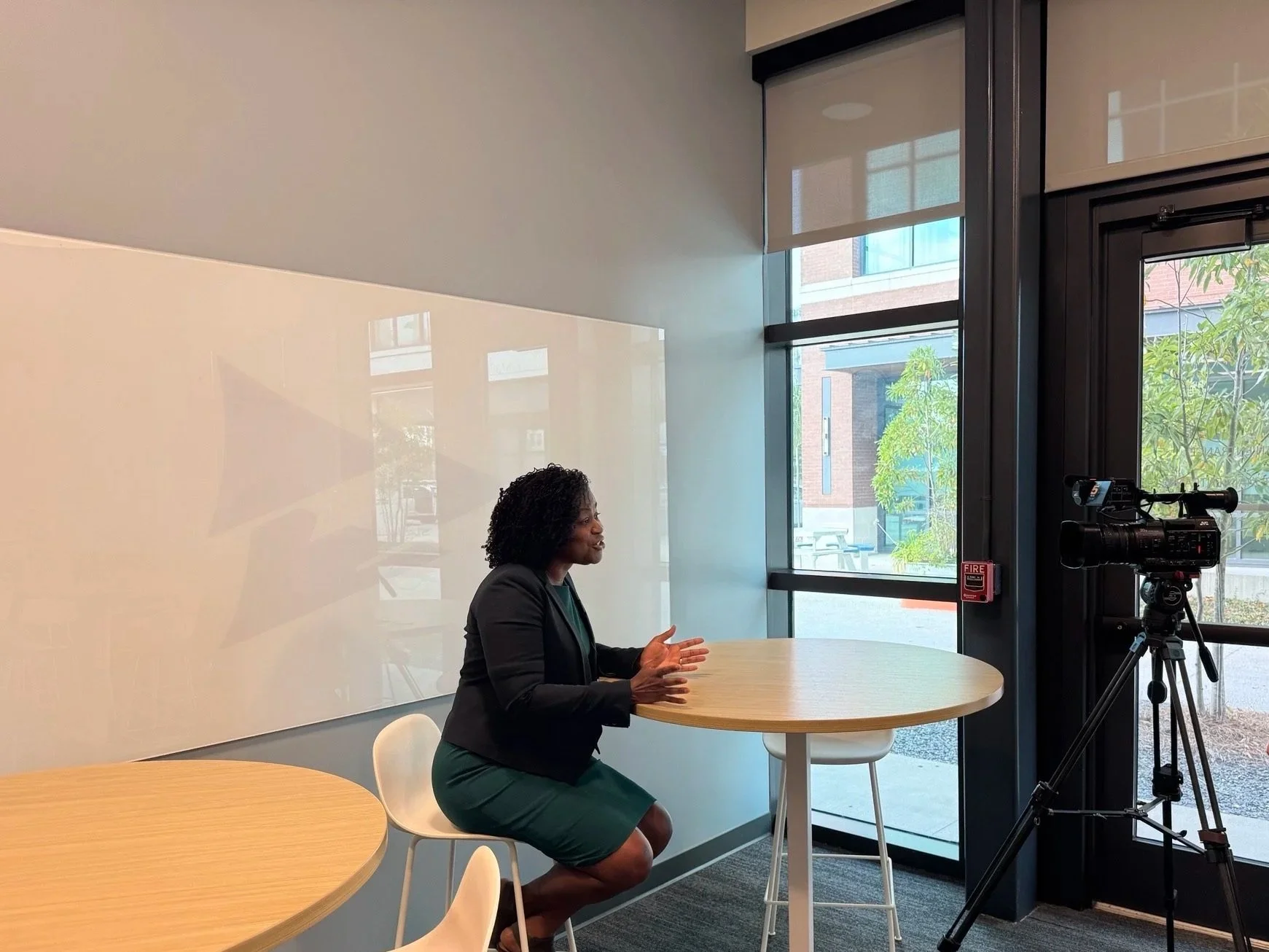 Tanqueray Edwards gesturing with her hands while speaking during an interview for Channel 5 news on AI consulting, AI strategy, AI literacy, and AI adoption.  