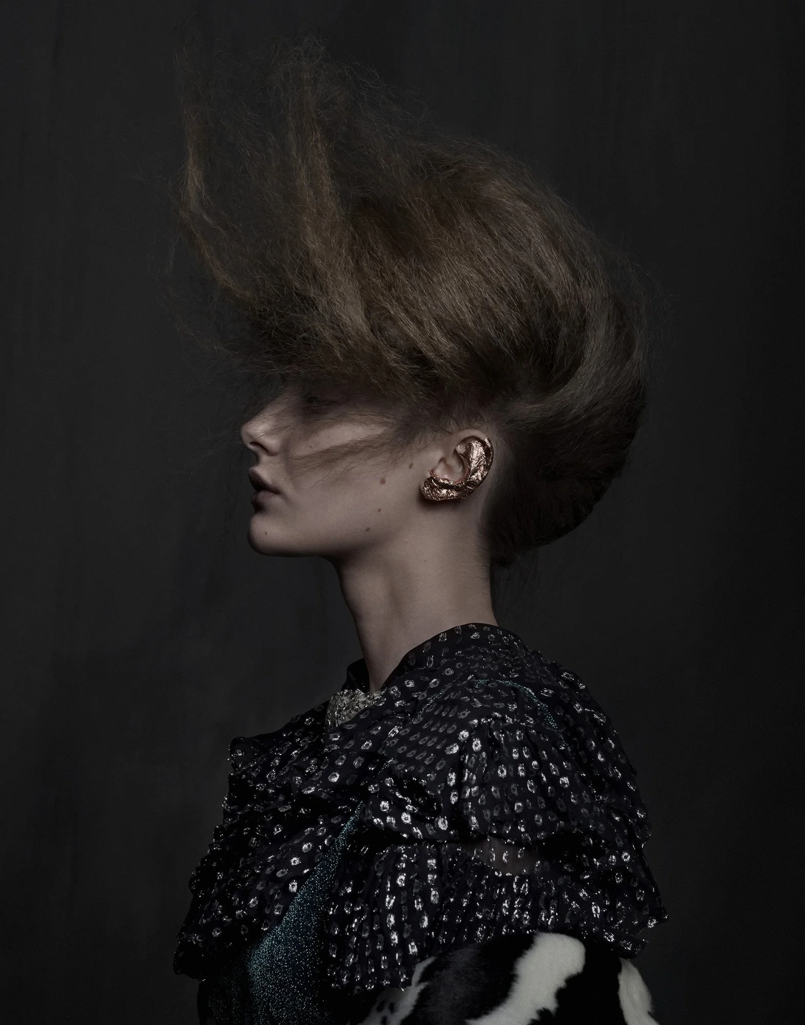 Fashion movement — earring detail with wind-blown hair