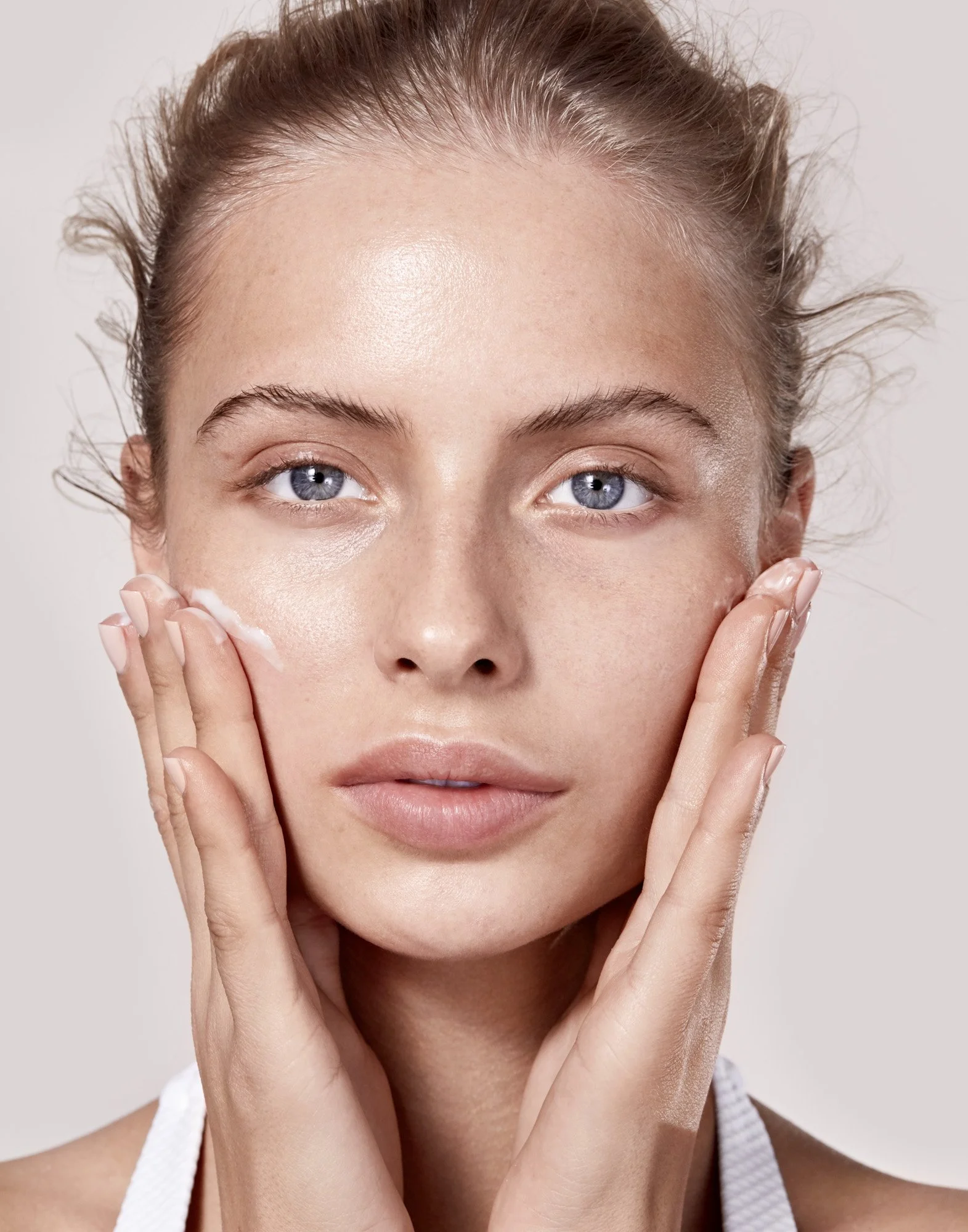 Skincare portrait — hands on face, natural beauty