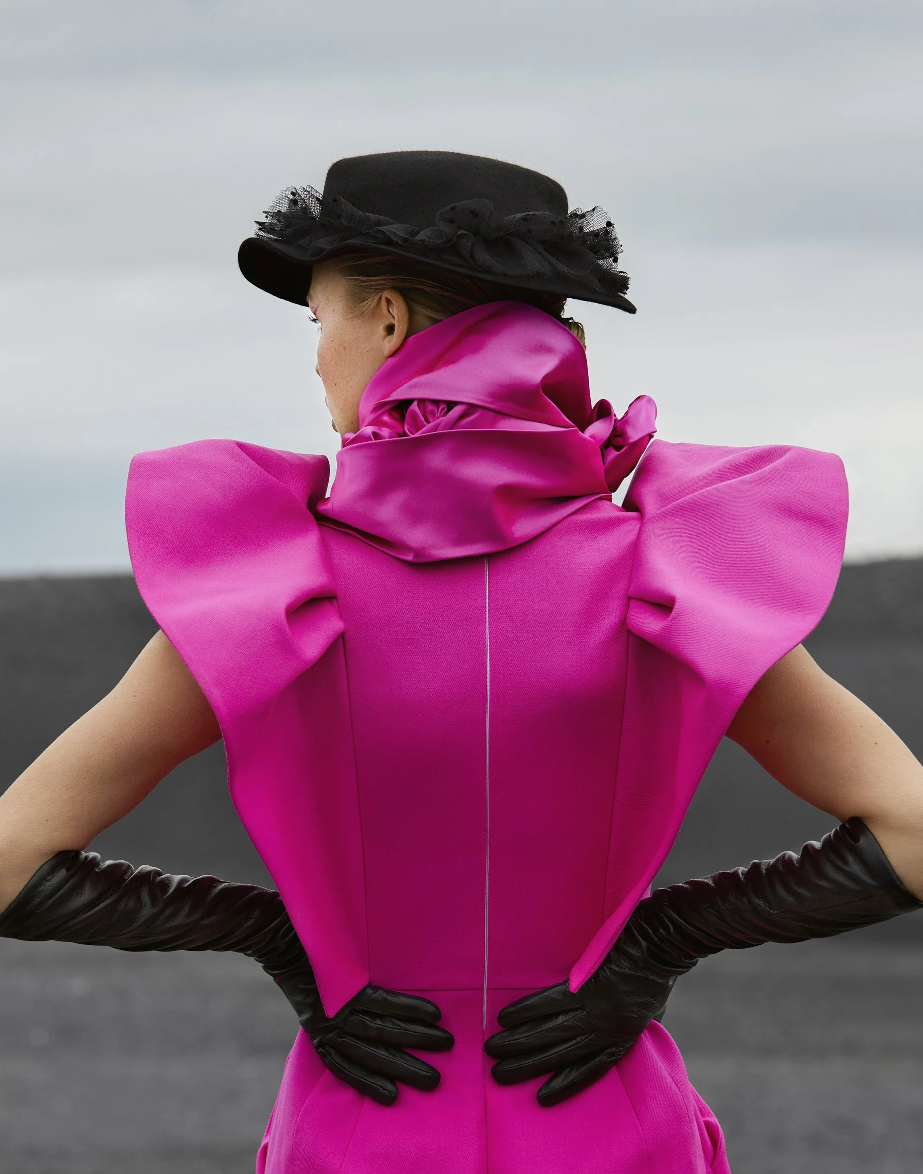 Fashion editorial, magenta and black — considered styling, coastal backdrop