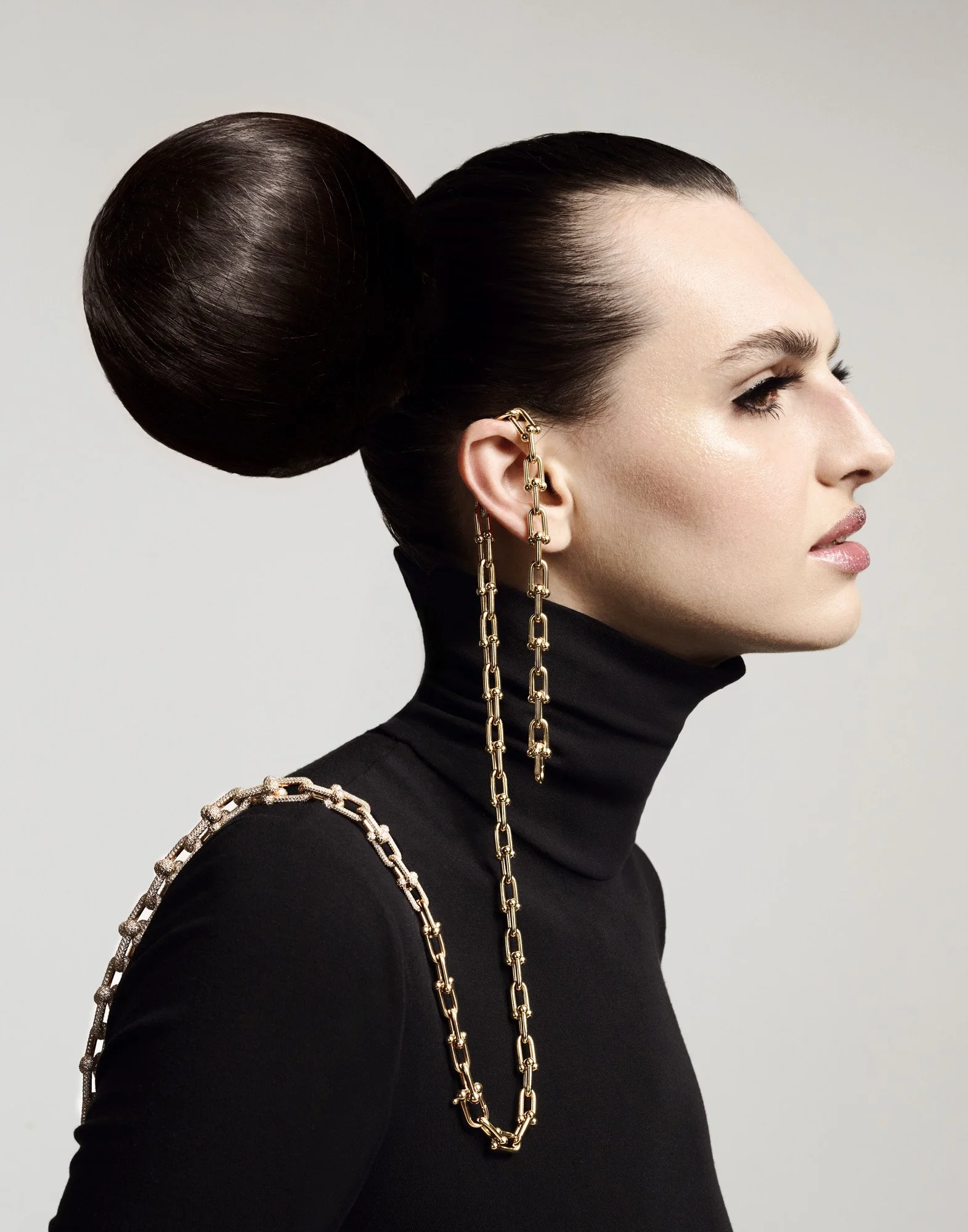 Chain ear cuff and sleek bun in profile, jewellery photographer London Benjamin Kaufmann