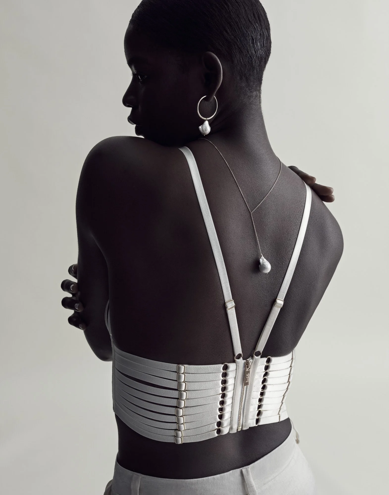 Pendant necklace on a bare back, jewellery photography London by Benjamin Kaufmann