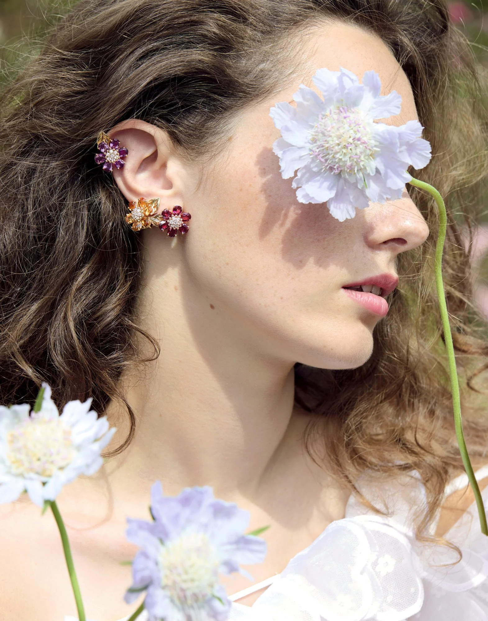 Ear cuffs and a blue flower over the eye, editorial jewellery photography by Benjamin Kaufmann