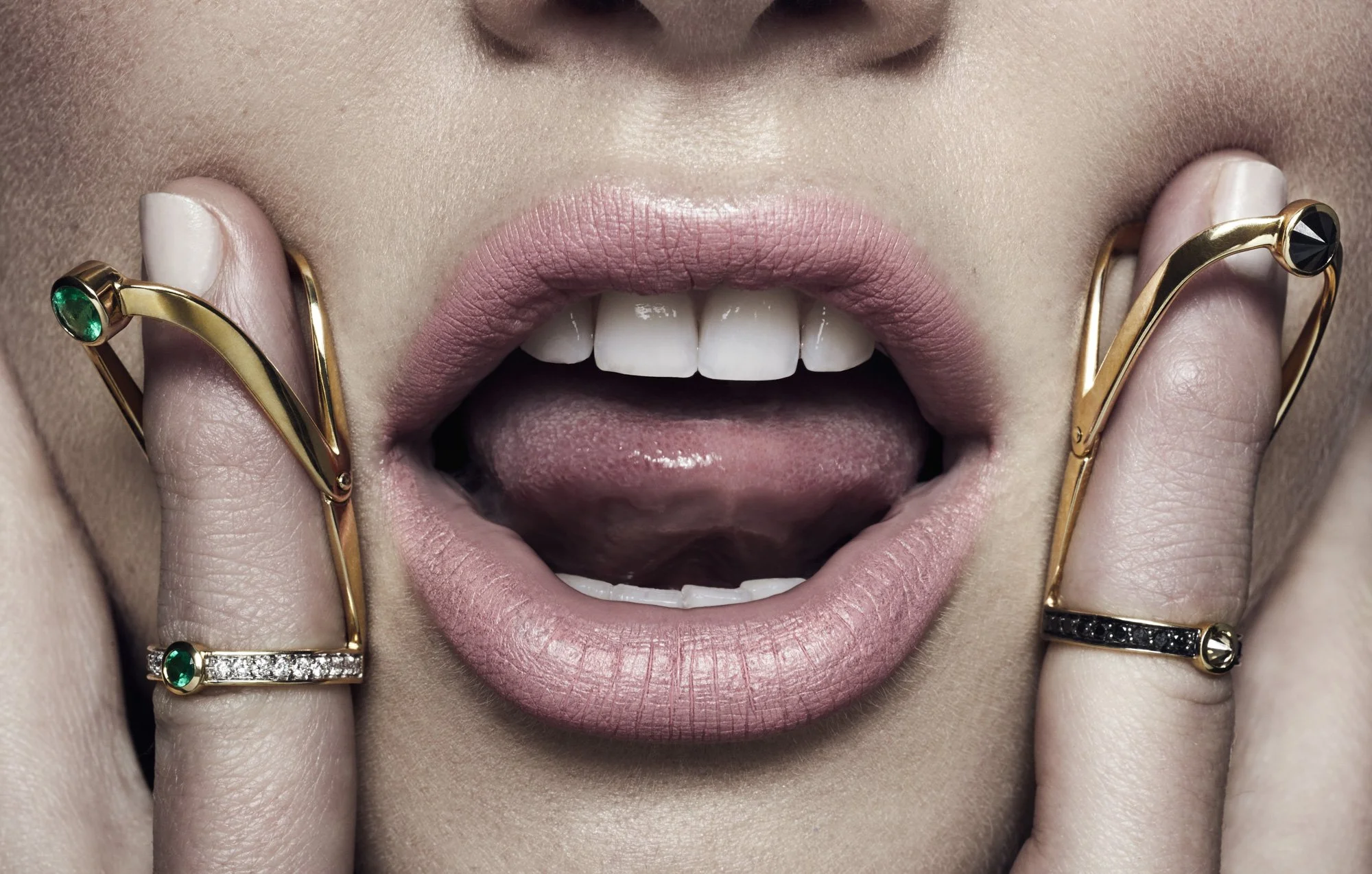 Finger rings framing an open mouth, jewellery photographer London Benjamin Kaufmann