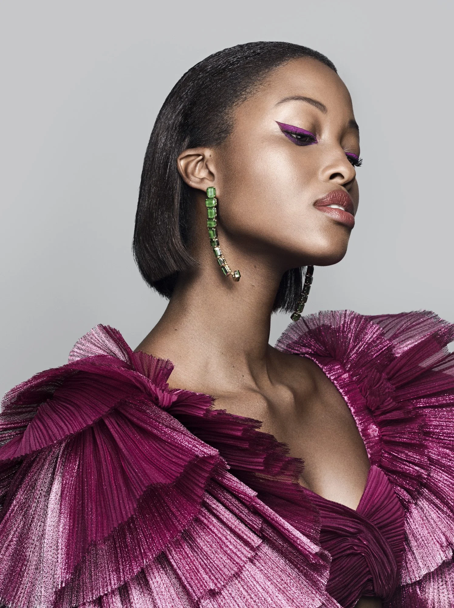 Green drop earring and graphic liner on deep skin, jewellery photography London by Benjamin Kaufmann