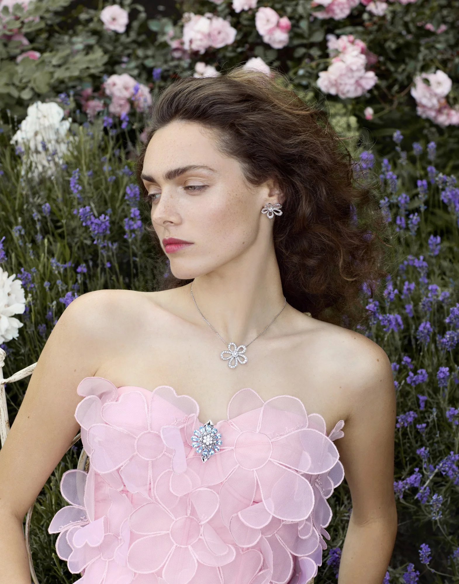 Pendant necklace and petal dress in a rose garden, editorial jewellery photography by Benjamin Kaufmann