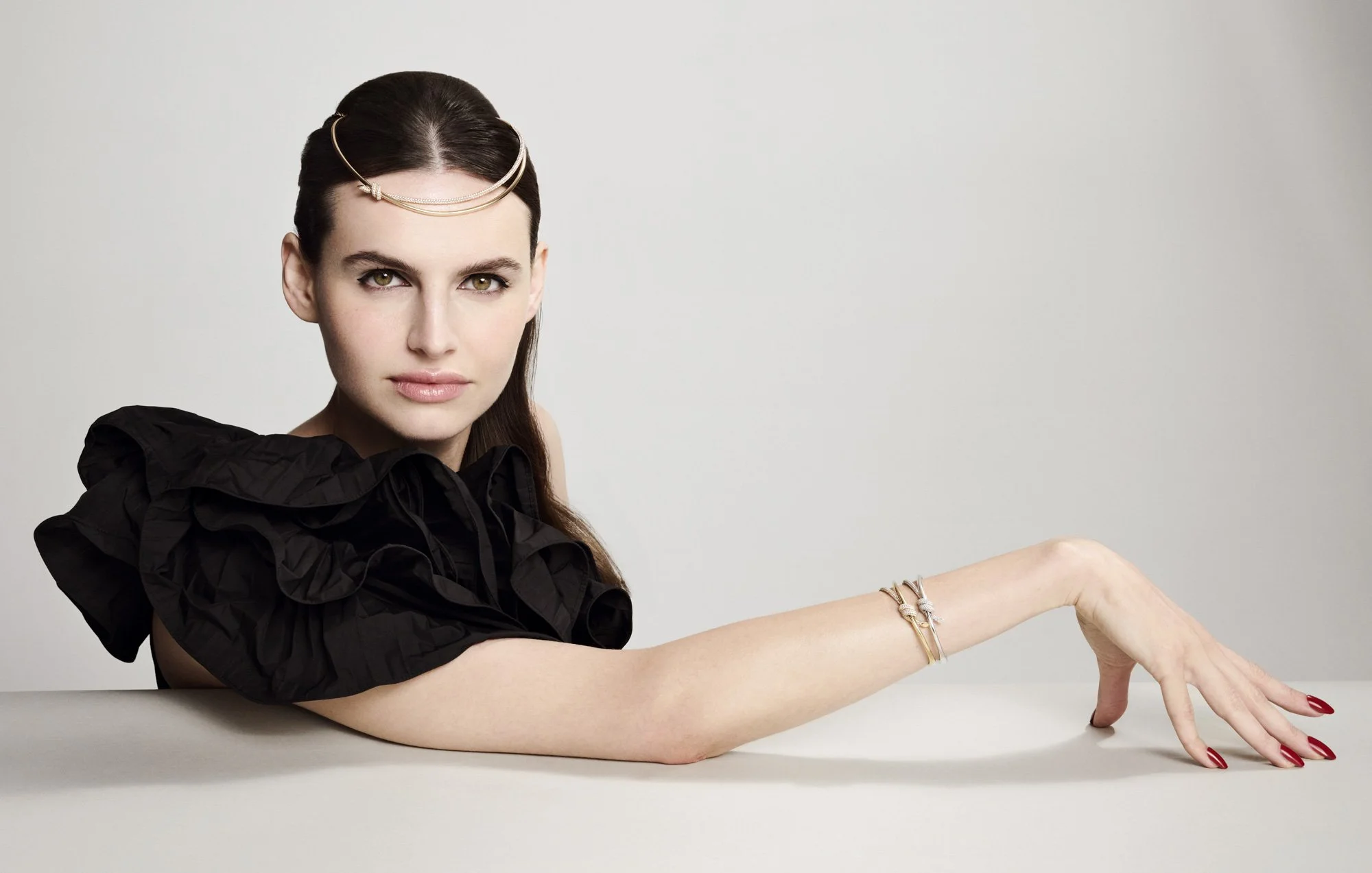 Bracelet on an outstretched arm, black ruffles, jewellery photography London by Benjamin Kaufmann