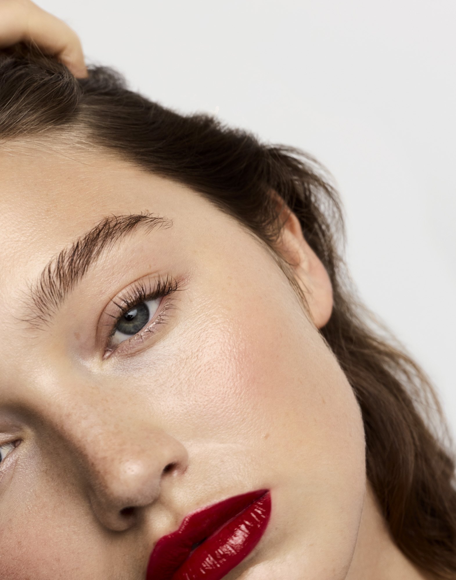 Glossy red lipstick on freckled skin, make-up photography London by Benjamin Kaufmann