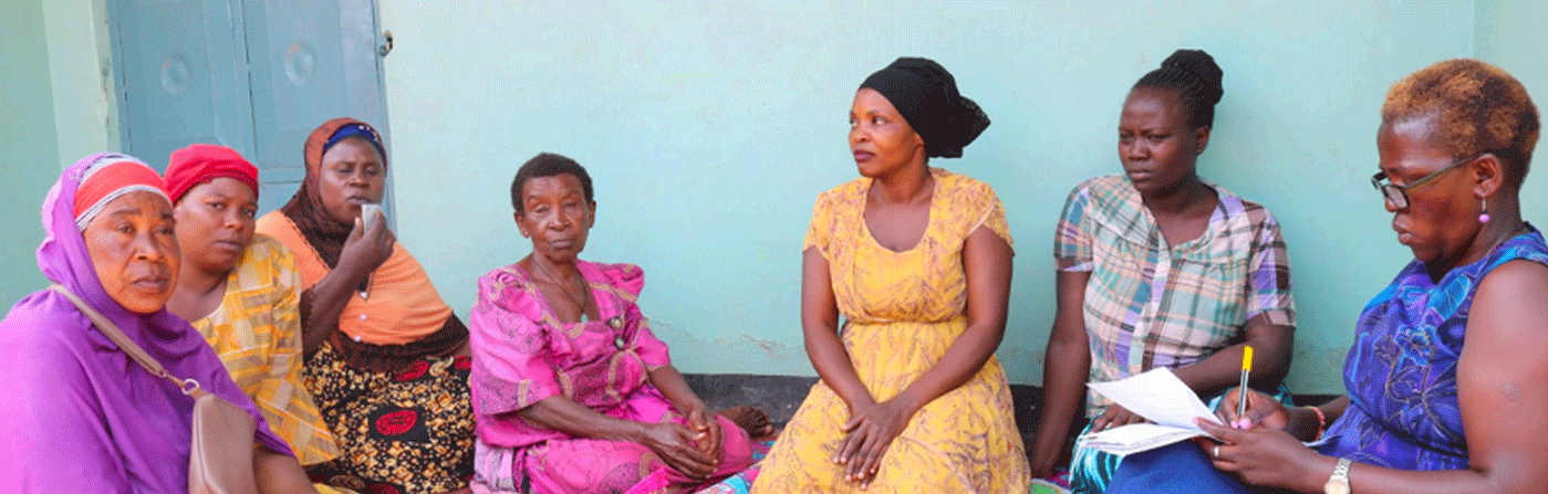 A group of women sitting together outdoors during a community health discussion