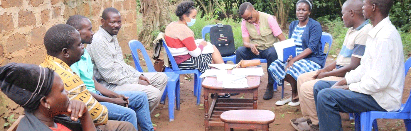 A team gathered around a table reviewing sticky notes and design materials during a workshop session