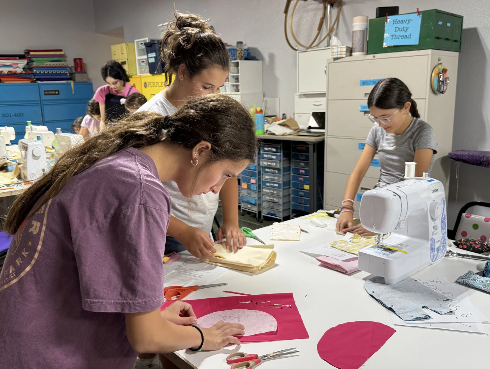 Children work on pinning and cutting out projects