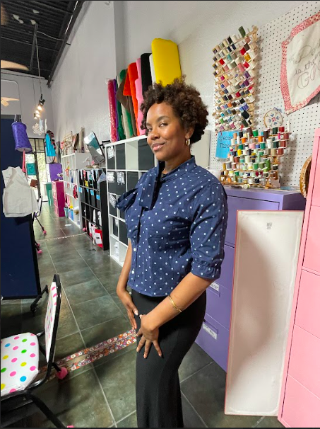 A woman poses with a shirt created by modifying an old men's shirt