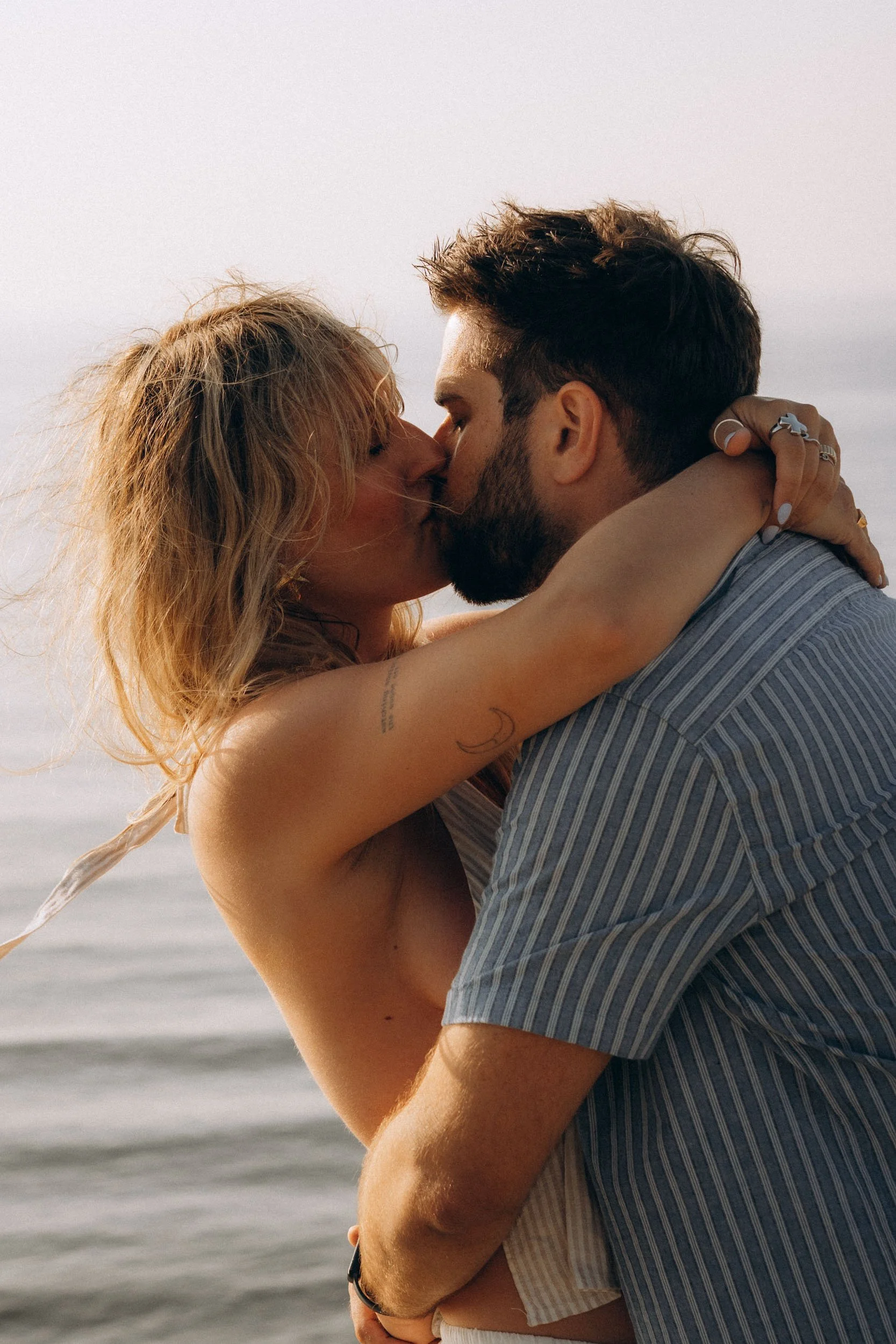 A couple sharing a kiss at the beach during sunset. Praia do Castelejo, Algarve couple photographer