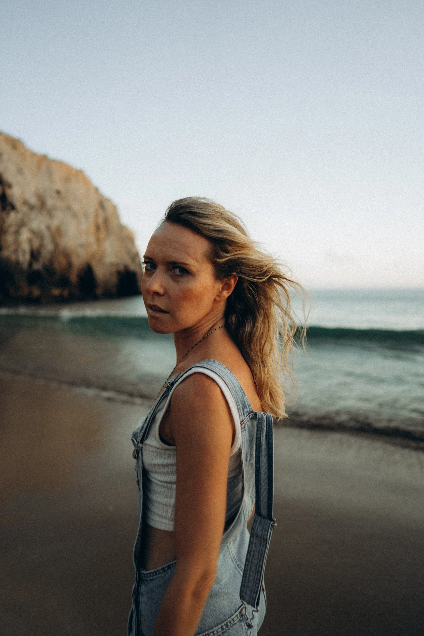 Cinematic beach portrait in Algarve — lifestyle photography at Beliche with ocean and limestone cliffs