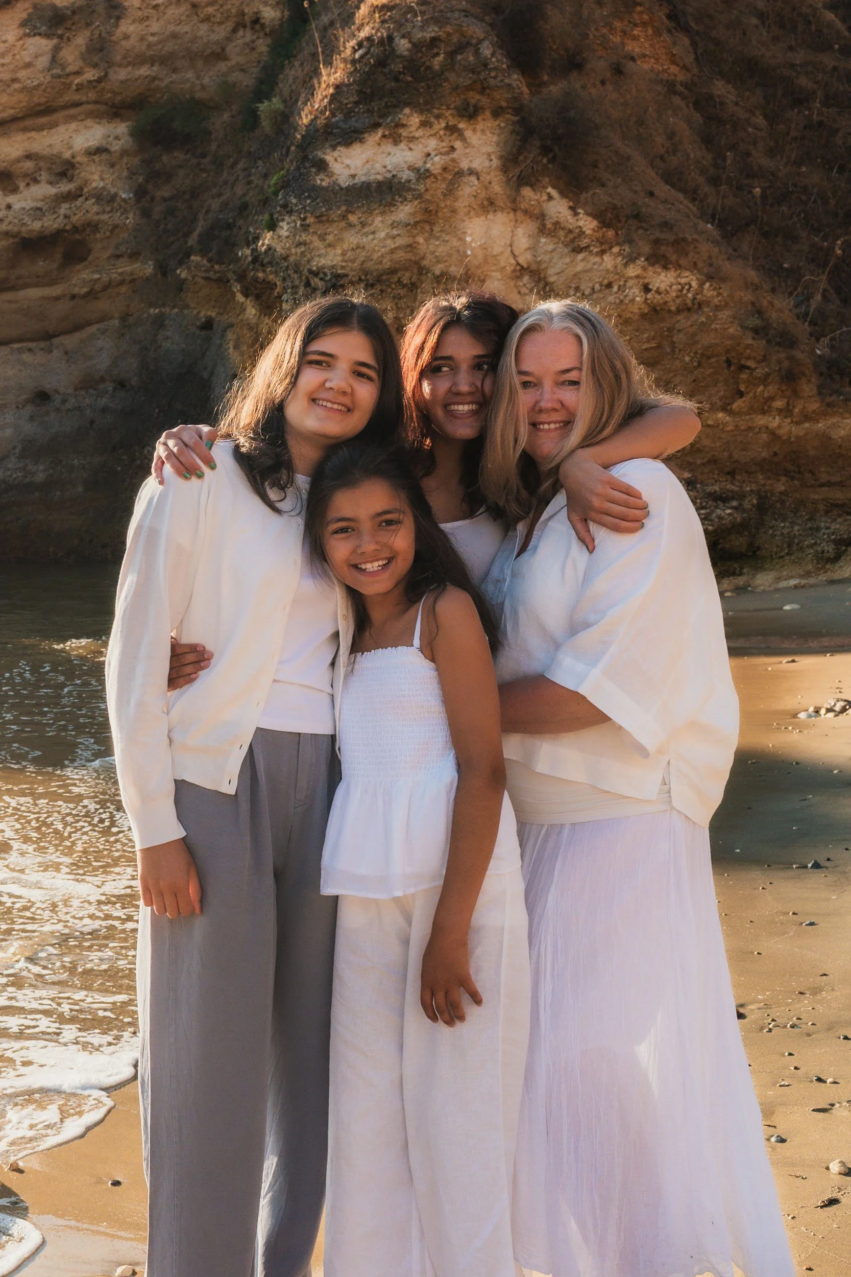 Mother and daughters portrait at Praia do Camilo beach in Lagos, Algarve.