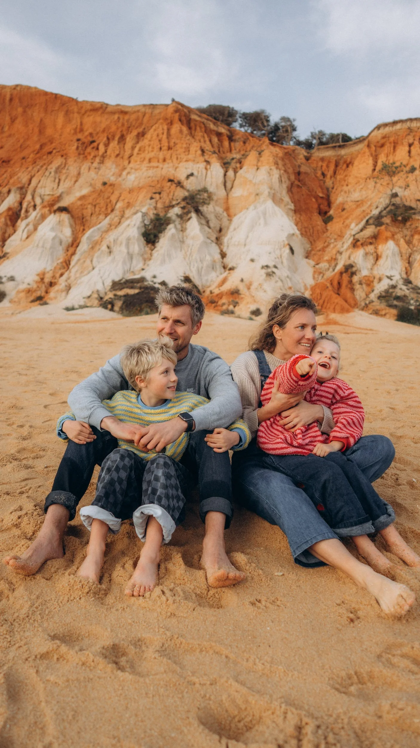 Family portrait with red cliffs during photoshoot at Falésia beach Albufeira Algarve