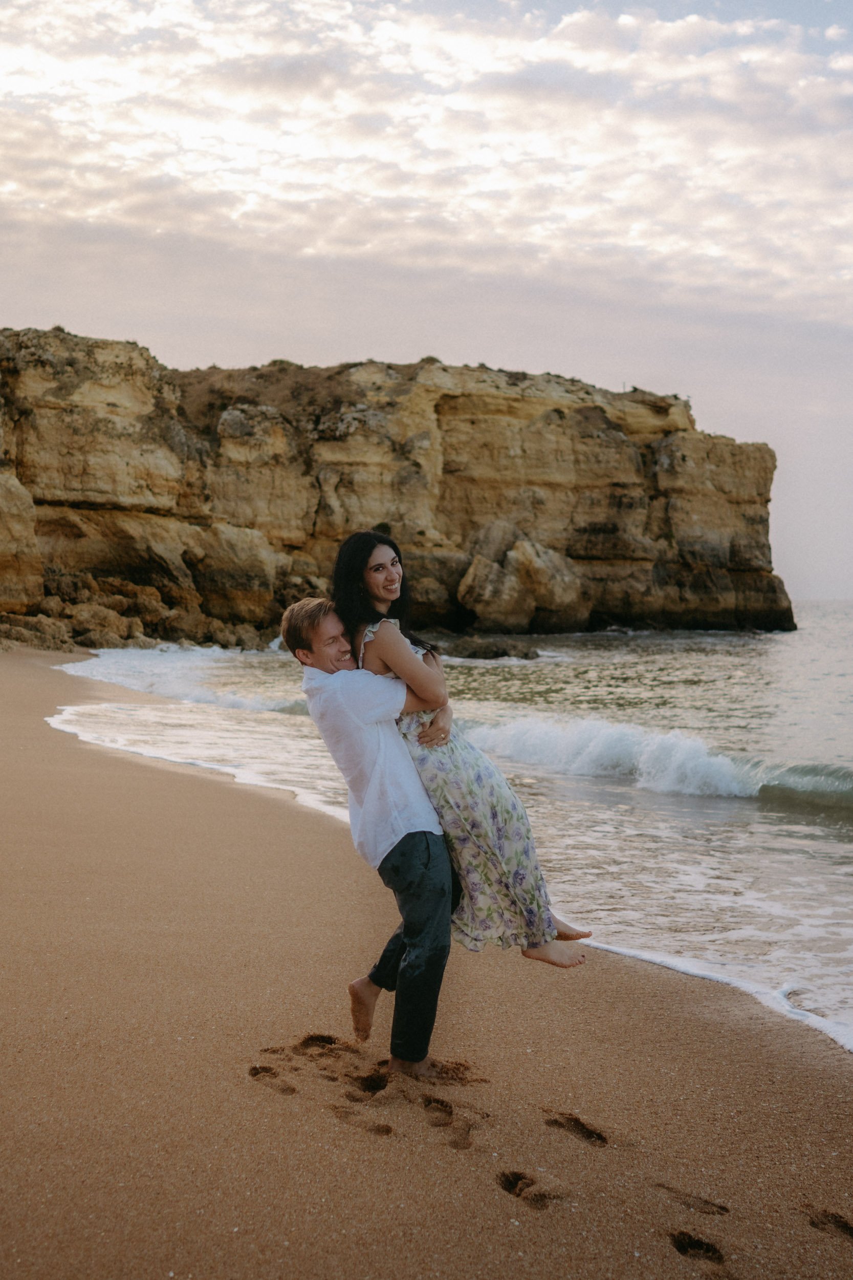 A spontaneous moment on the shoreline, with the cliffs in the background and soft waves touching the sand.
Praia da Coelha allows space for movement and real interaction — nothing staged, just connection.