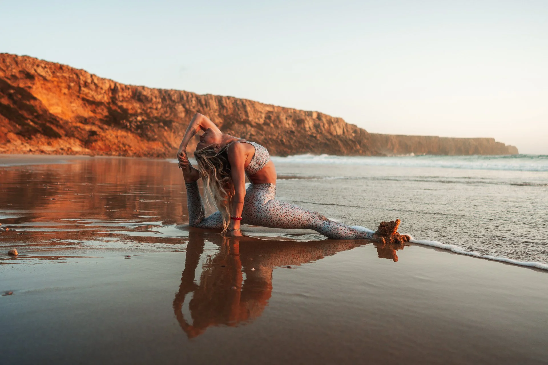 Yoga pose at the ocean’s edge in the Algarve, body and breath moving with the tide at golden hour.