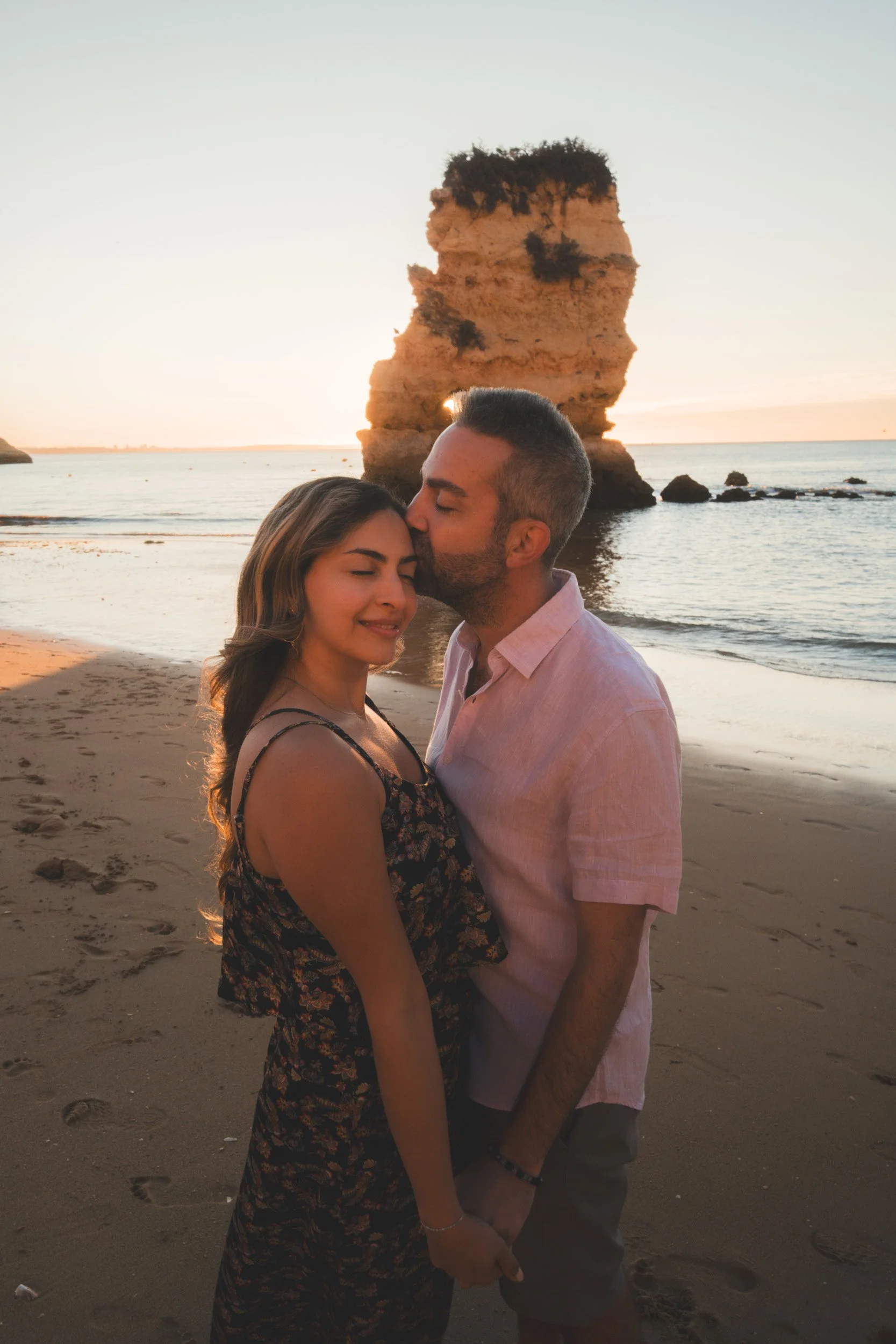 Golden hour couple portrait at Praia Dona Ana, Lagos — soft light, natural movement and authentic connection.