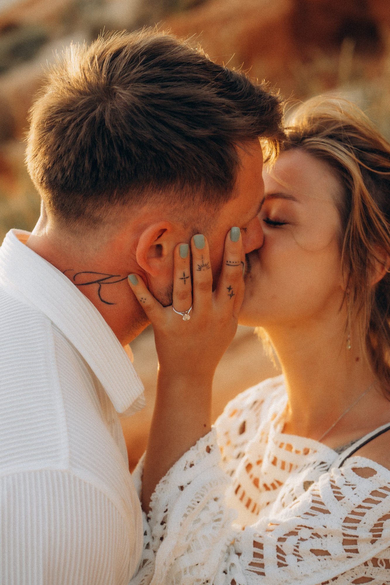Close-up engagement kiss with ring detail, proposal photography Algarve golden hour