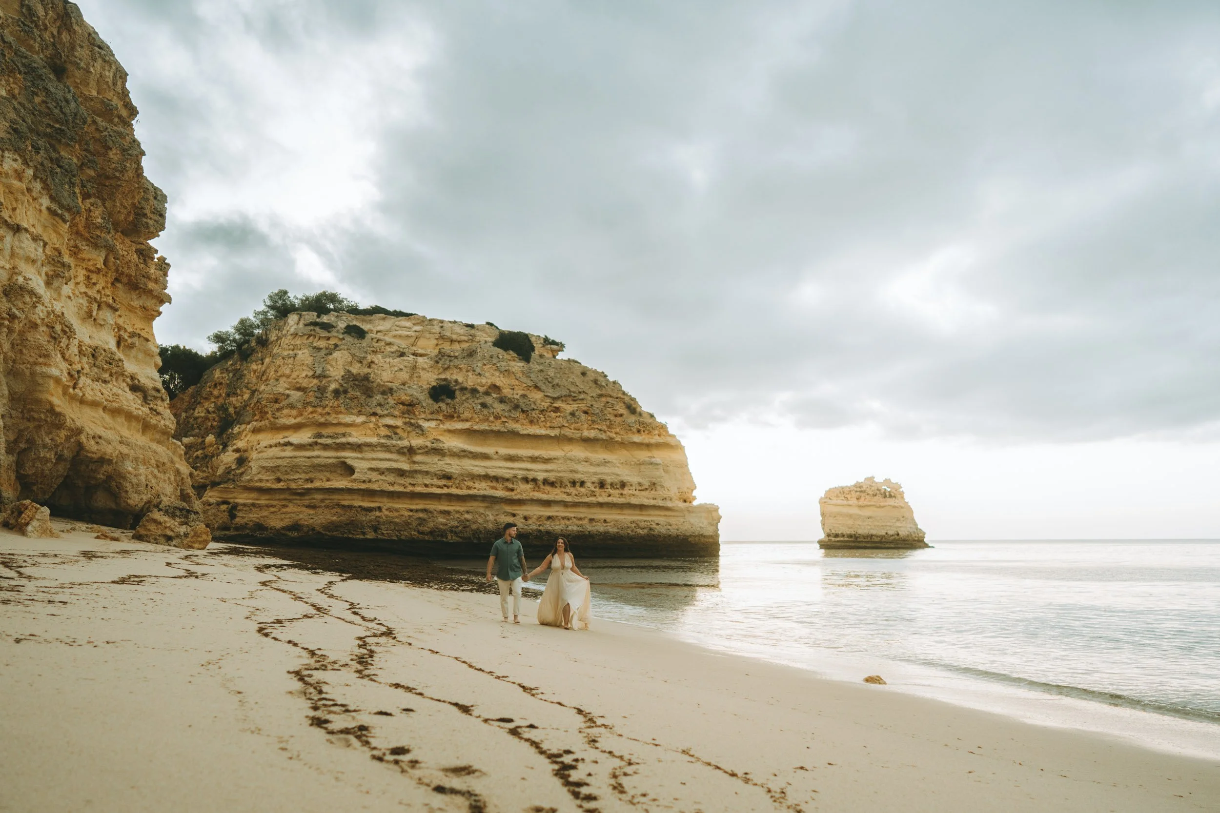 Romantic couple photoshoot at Praia da Marinha in the Algarve, Portugal, captured on the iconic golden cliffs overlooking the Atlantic Ocean.
