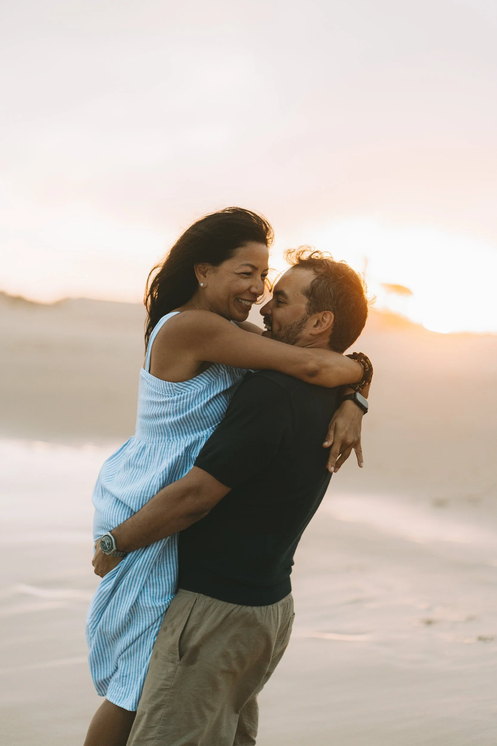 Natural family portraits taken at Martinhal beach, Algarve, with soft light and open surroundings.