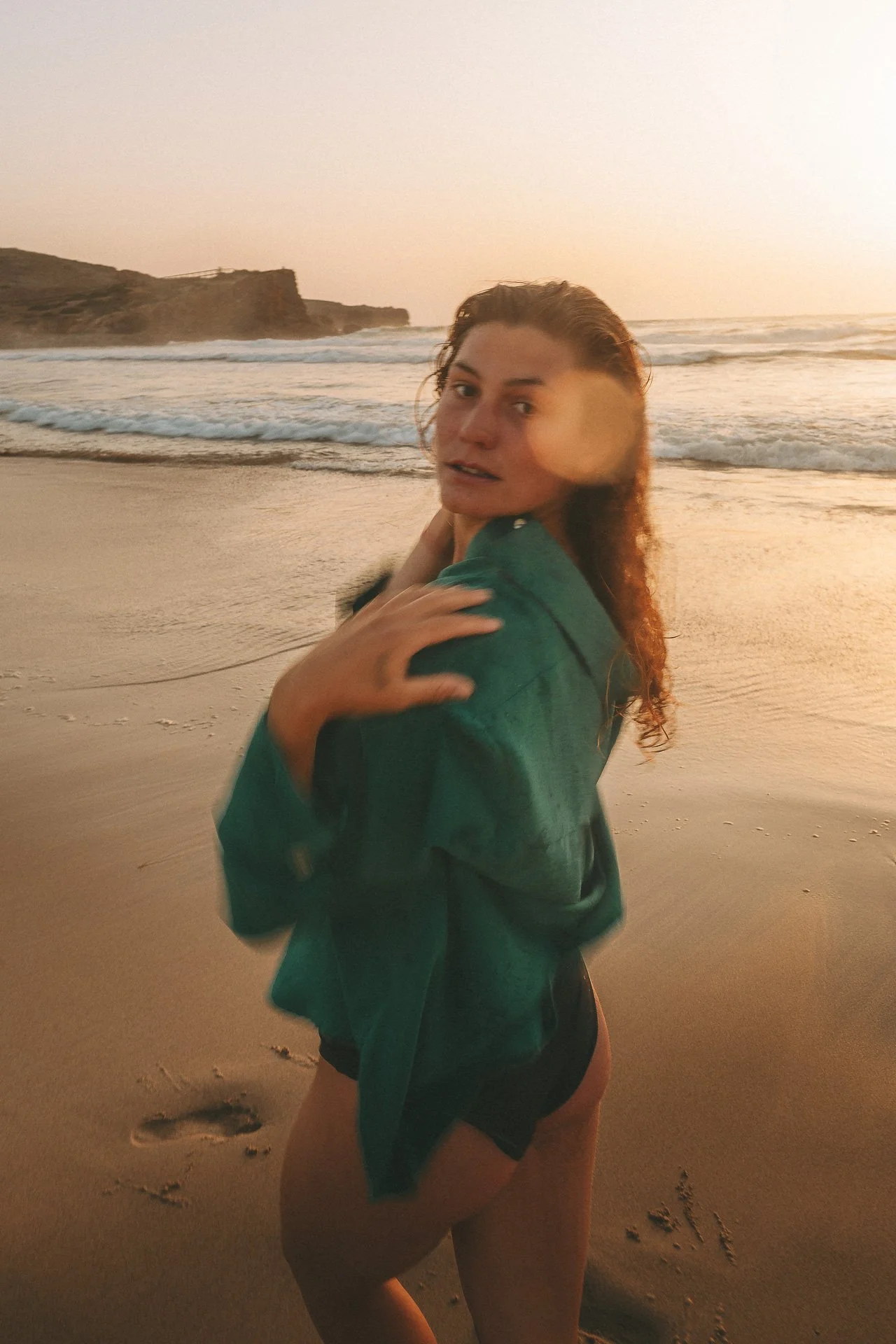 Golden hour portrait at Bordeira Beach in the Algarve, capturing movement, emotion and the raw beauty of the coastline.