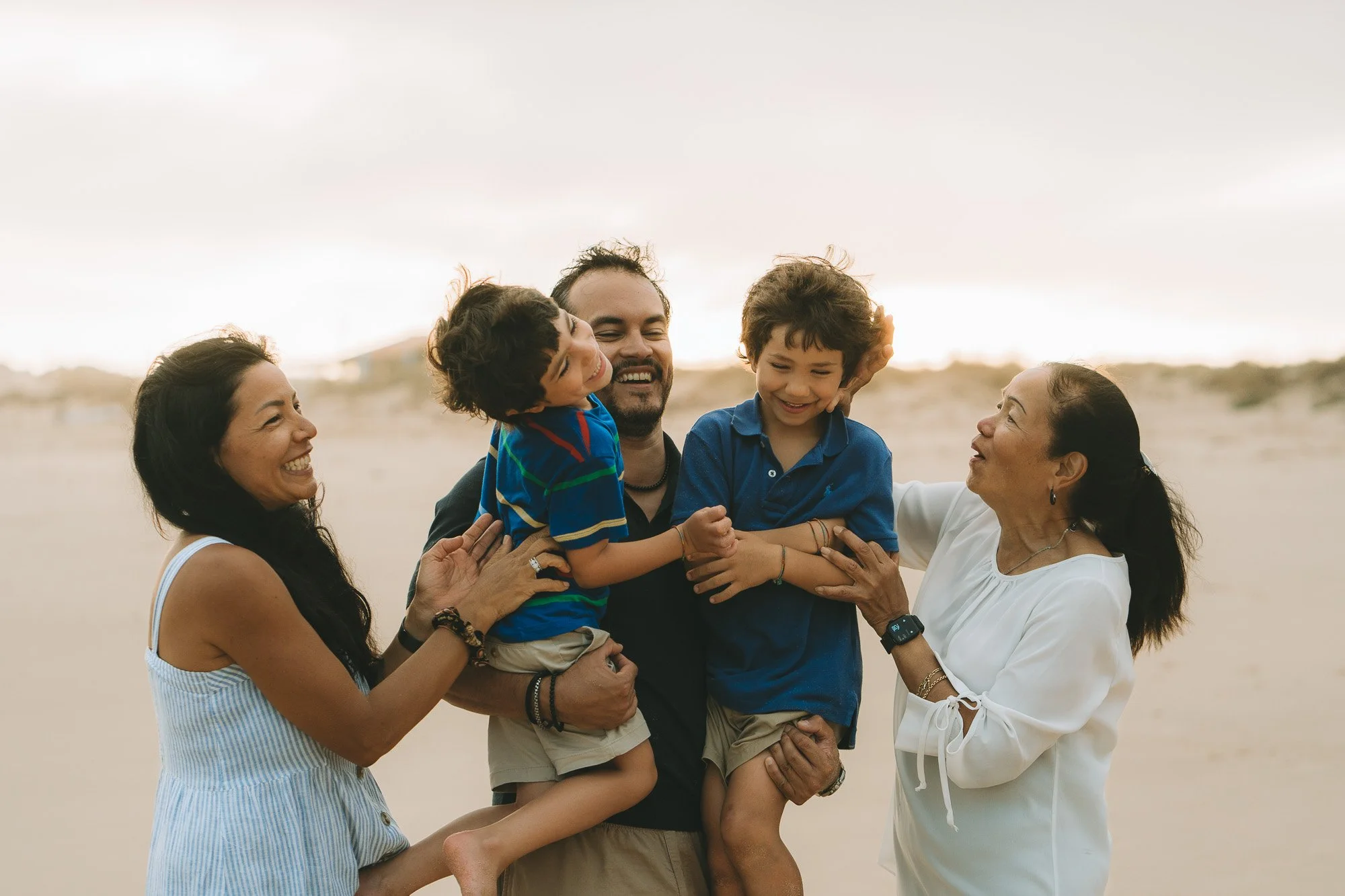 Family of 5 capturing candid moments by the beach at Praia do Martinhal, Sagres Algarve.
