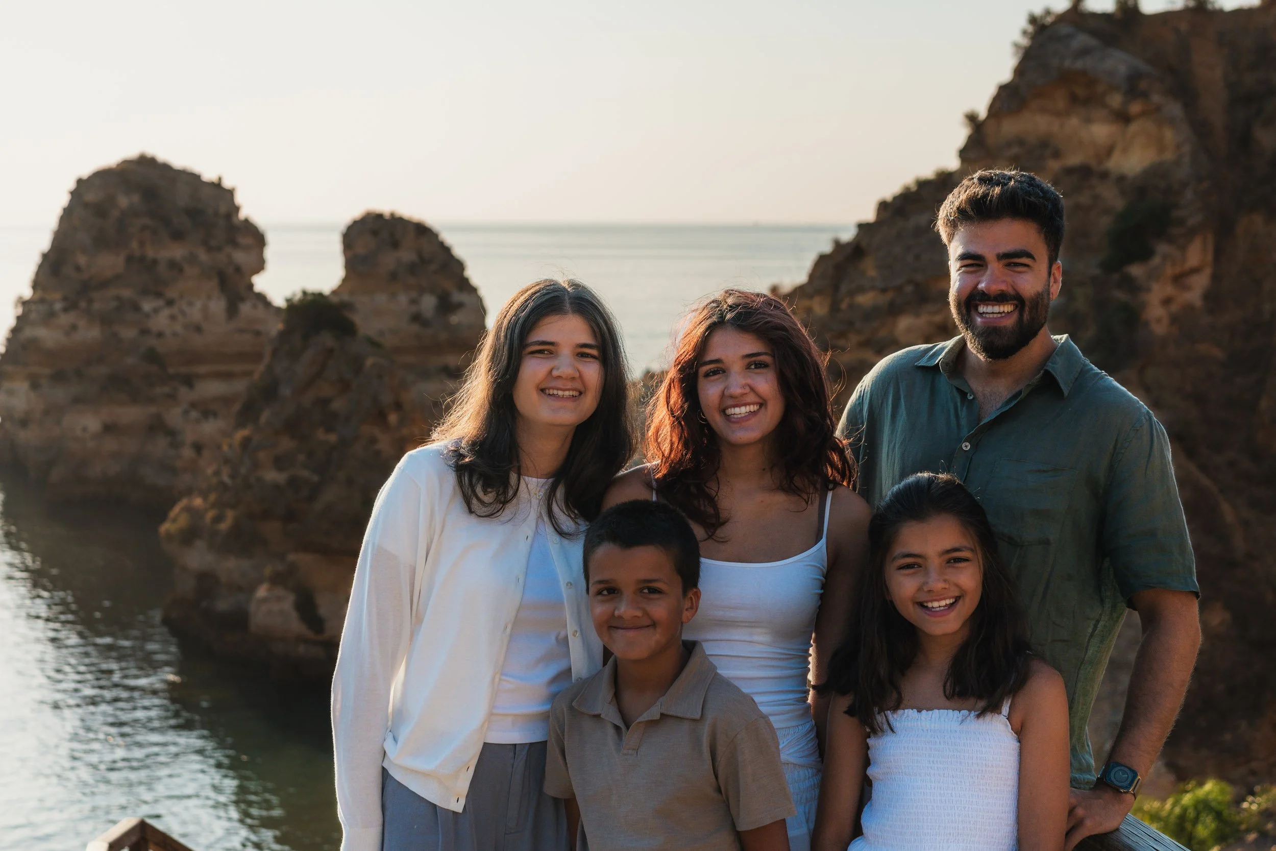 Natural family portrait during a photoshoot at Praia do Camilo, Lagos, Algarve.