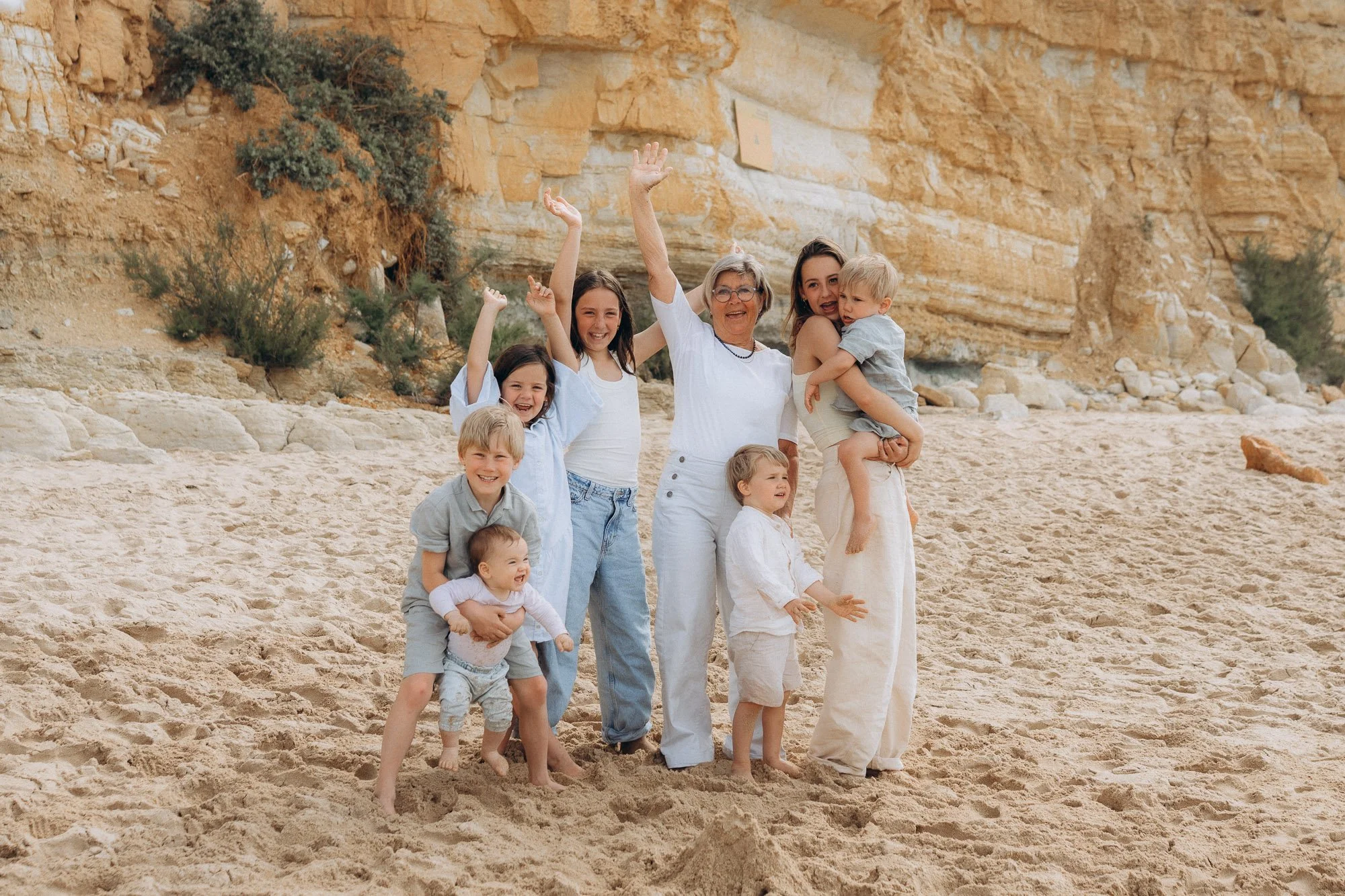 Multigenerational family celebrating on Algarve beach, grandmother with grandchildren, natural family photographer Portugal