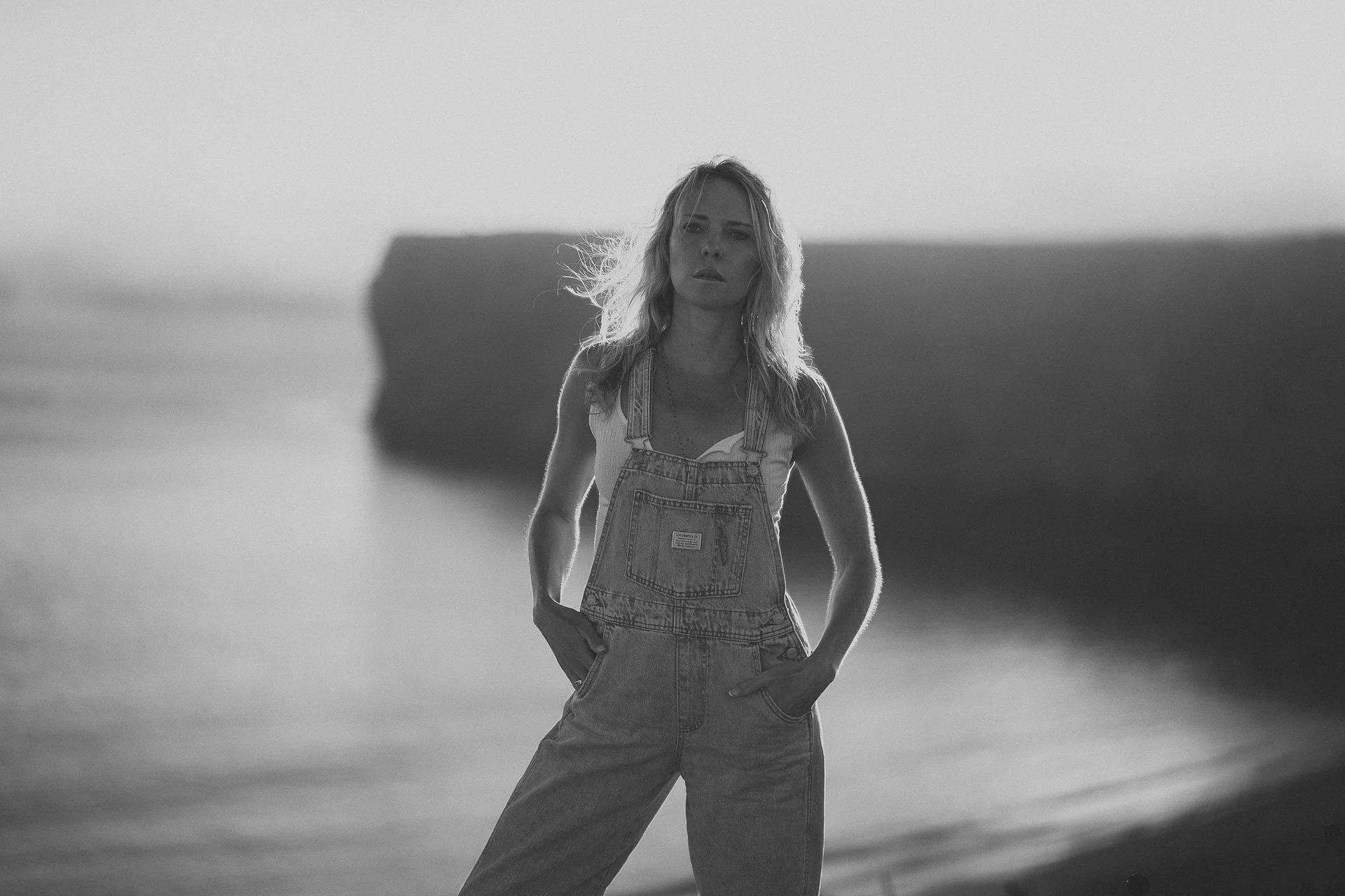 Black and white portrait at Beliche Beach, Sagres. Strong contrast, wind and cliffs shape a dramatic Atlantic scene.