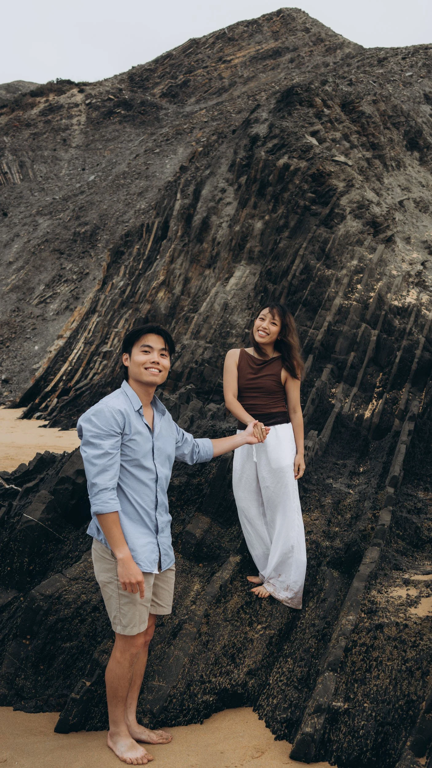 Couple photoshoot at Praia do Castelejo in the Algarve, exploring volcanic rock formations, blending adventure, connection, and natural storytelling photography.