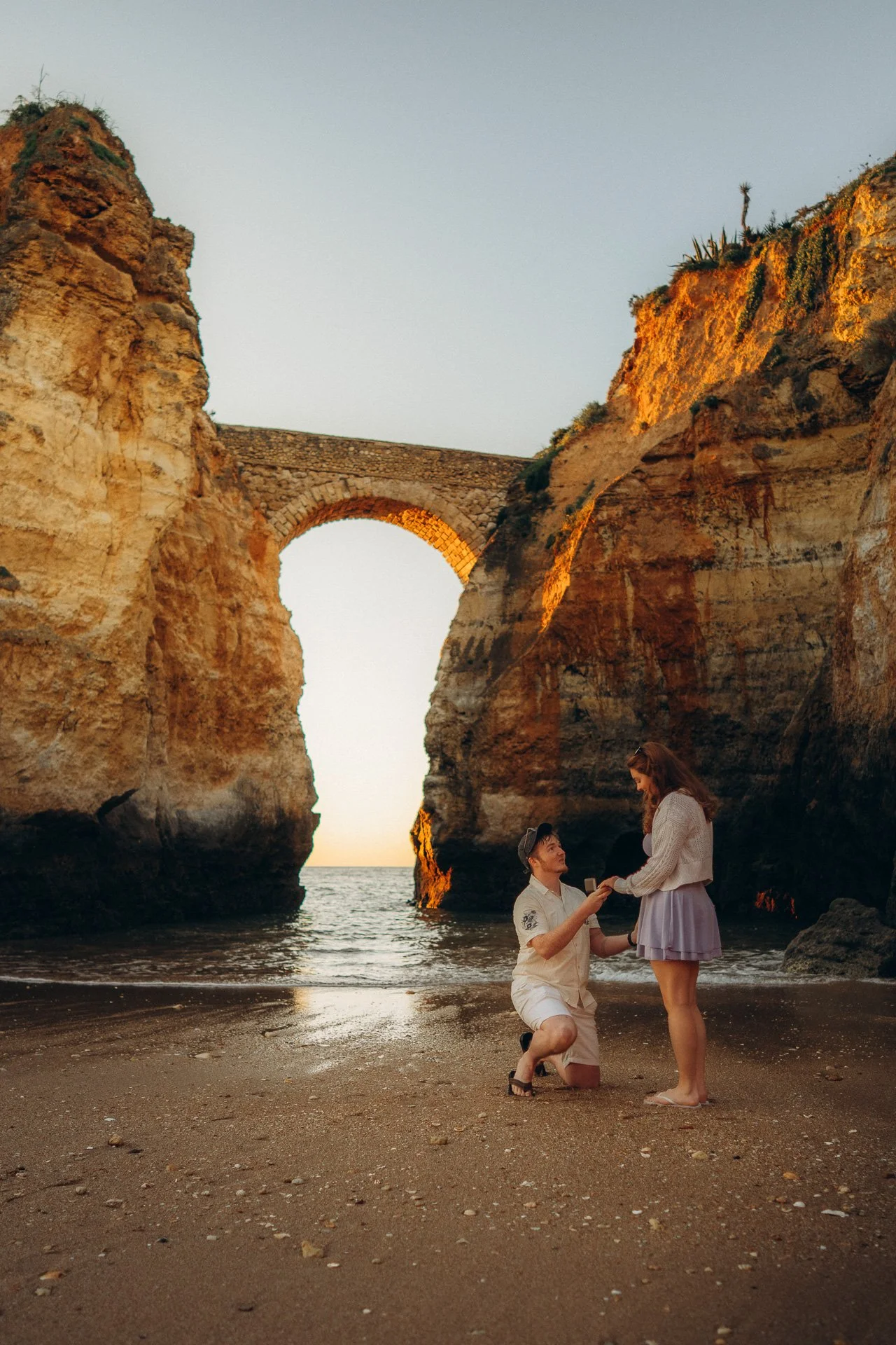 Surprise proposal at Praia dos Estudiantes in Lagos, Algarve with ocean cliffs and golden hour light