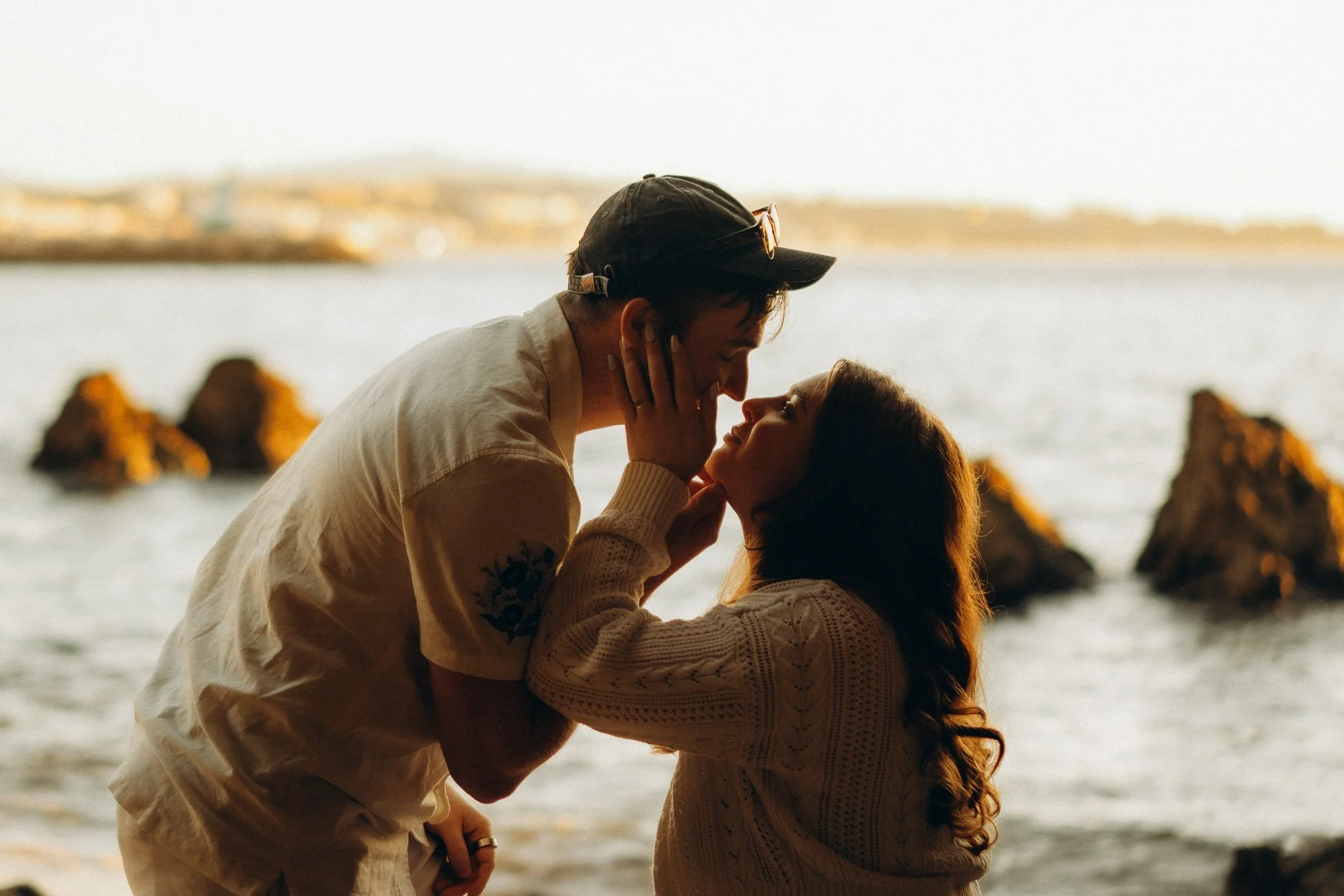 Romantic couple portrait at Praia dos Estudiantes, Lagos with ocean view and warm sunset light