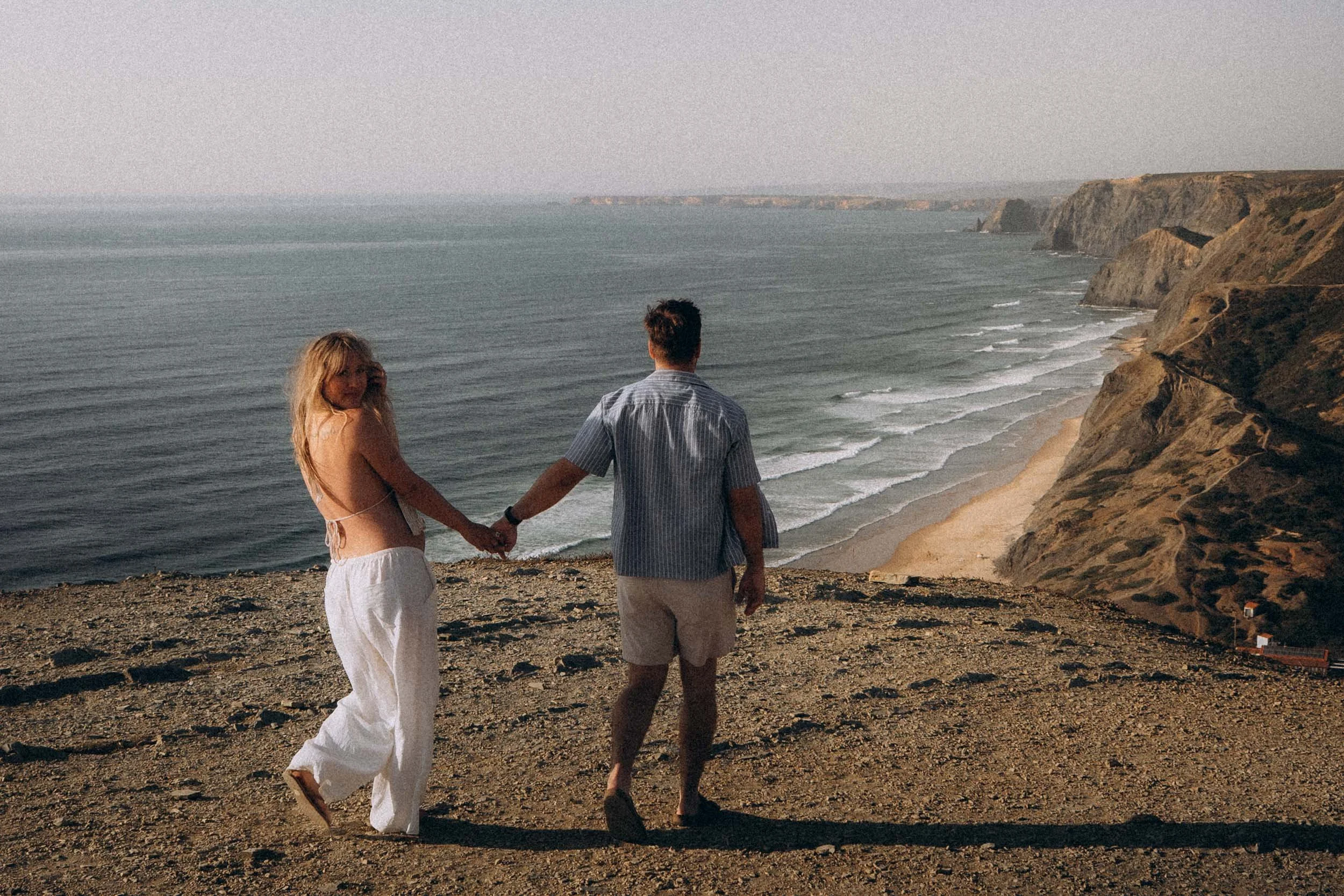 Romantic couple portrait during a sunset photoshoot in the Algarve, Portugal, highlighting emotional storytelling and natural light photography.
