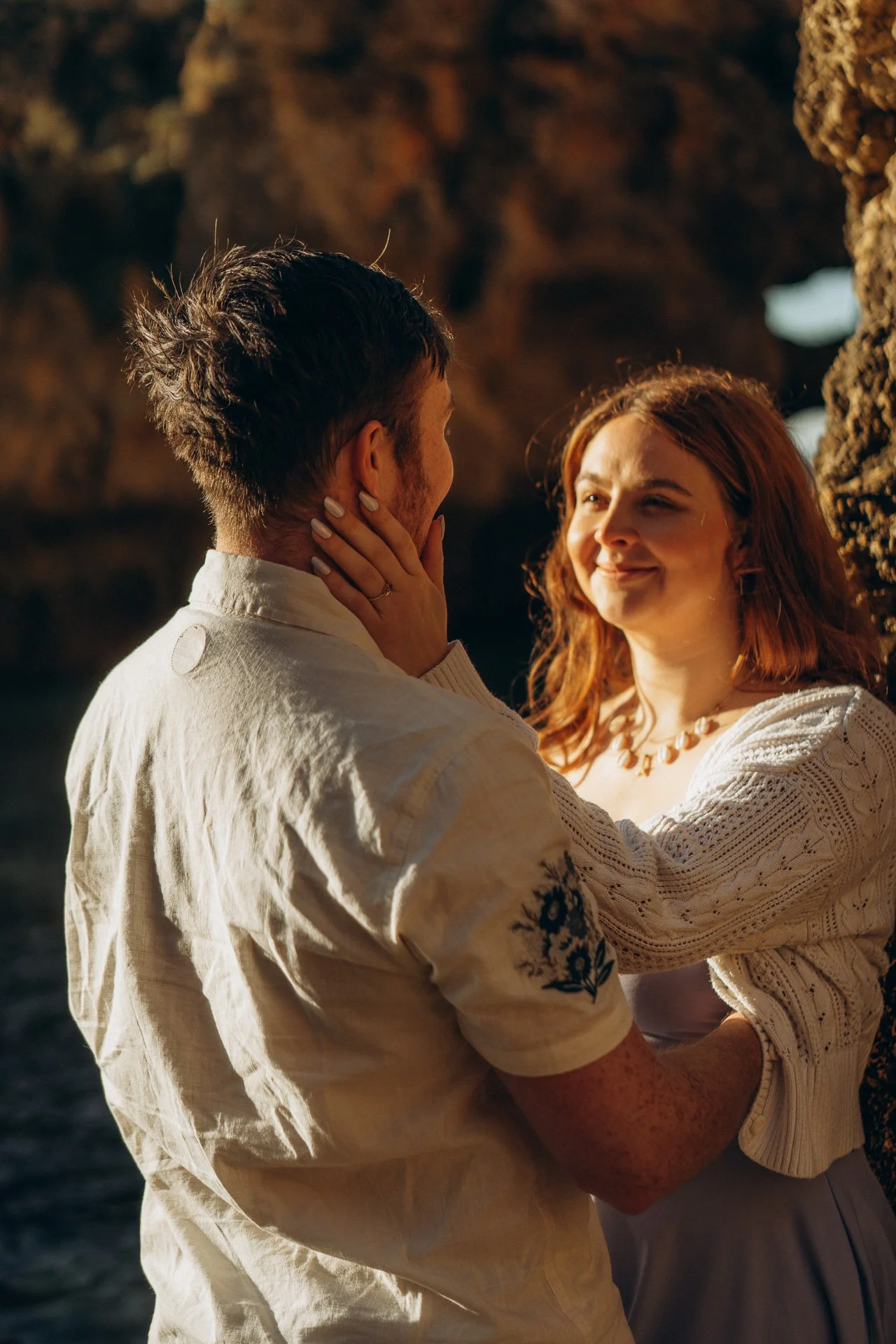 Intimate couple moment at Ponta da Piedade Lagos with warm golden light and ocean backdrop
