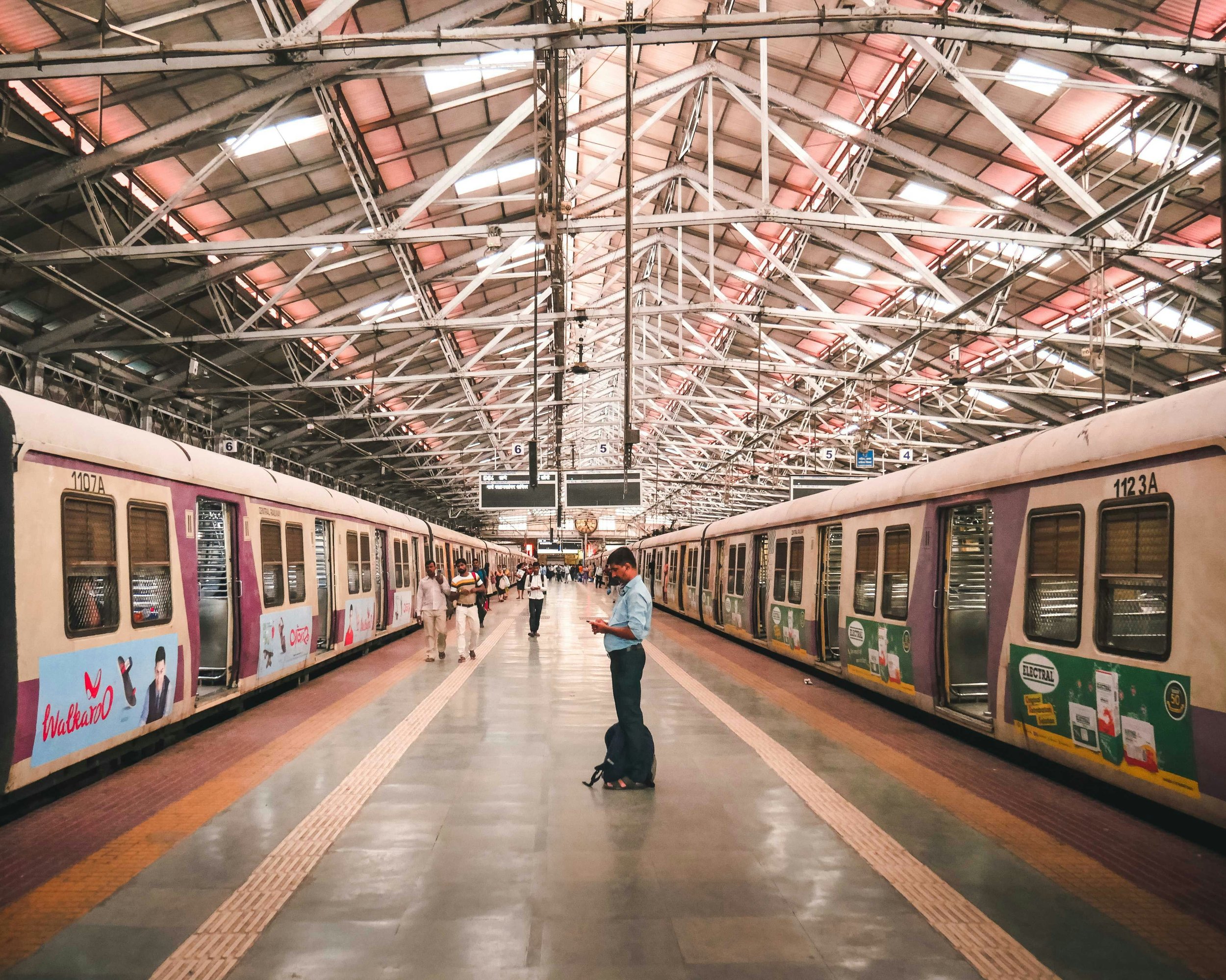 Commuters wait on a platform beside a halted Mumbai local train at Chhatrapati Shivaji Maharaj Terminus. Photo: Mayur Pokle / Unsplash