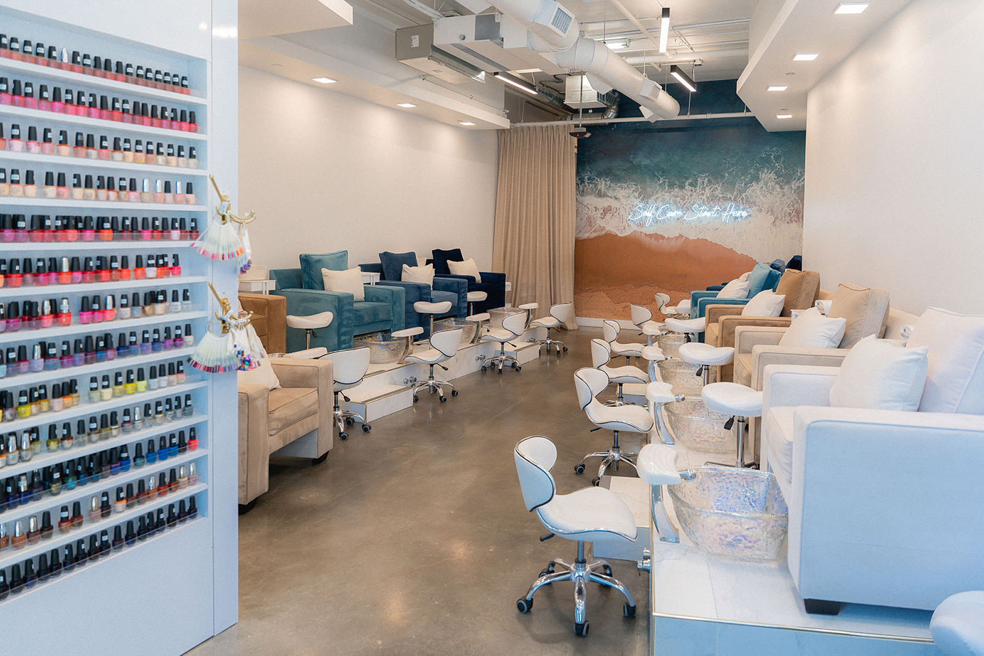 Exterior of Polish Nail Salon and Spa with a beach-themed window display.