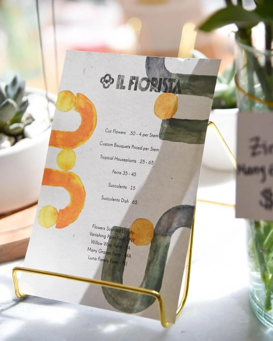 Il Fiorista menu with watercolor accents displayed on a gold stand | The Morris Project