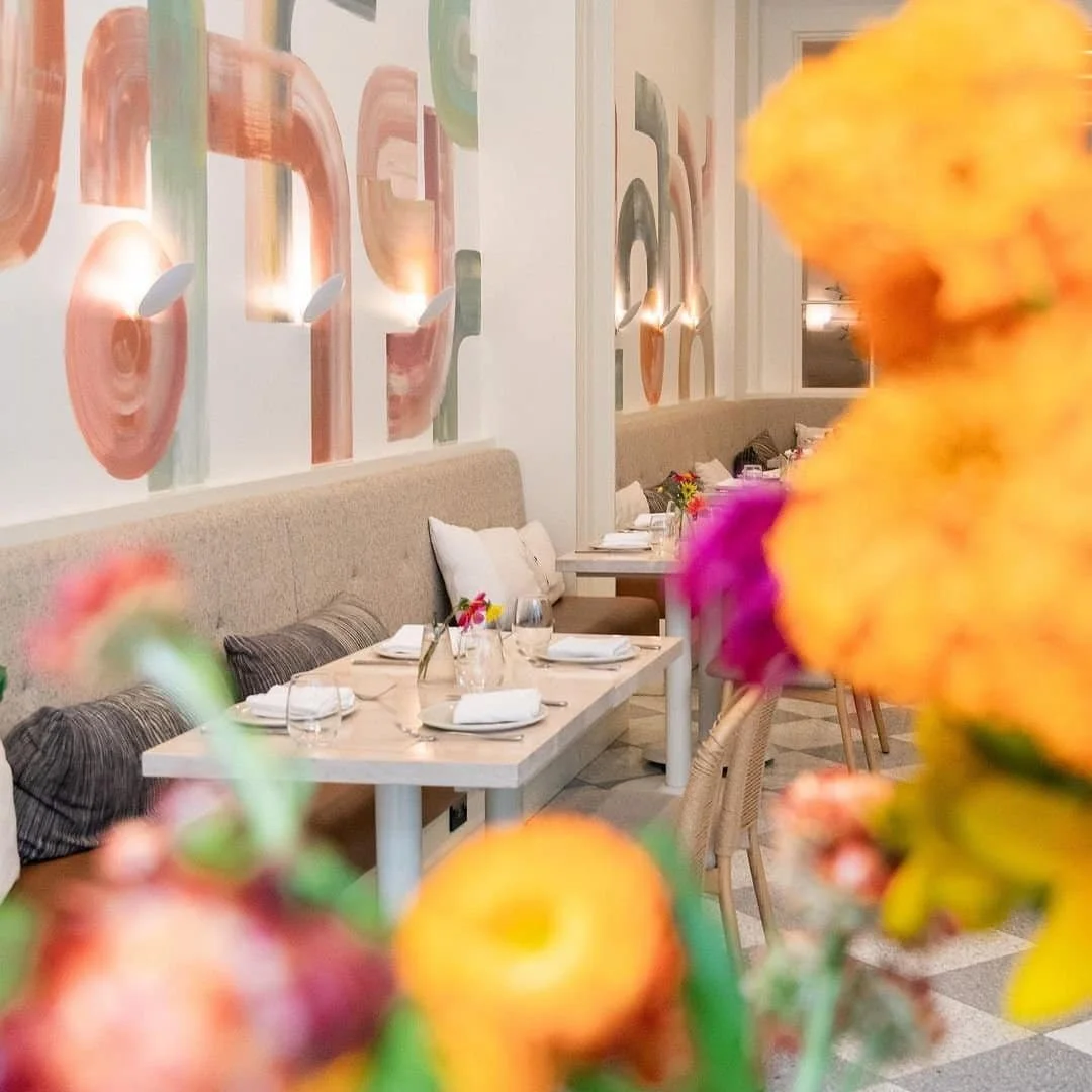 Elegant dining space with abstract wall art and fresh floral accents | The Morris Project