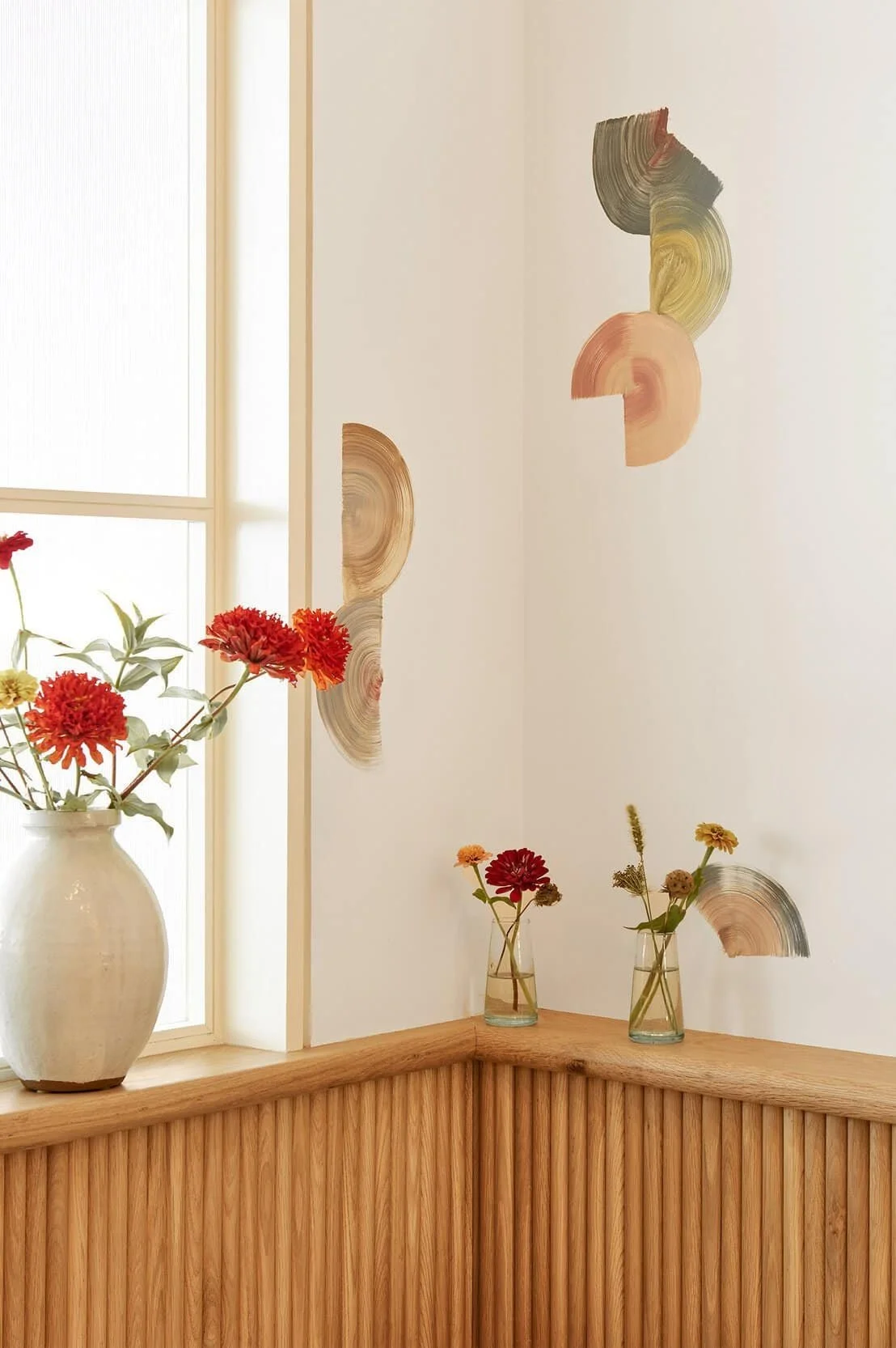 Elegant corner with wood paneling, abstract wall art, and fresh flowers | The Morris Project