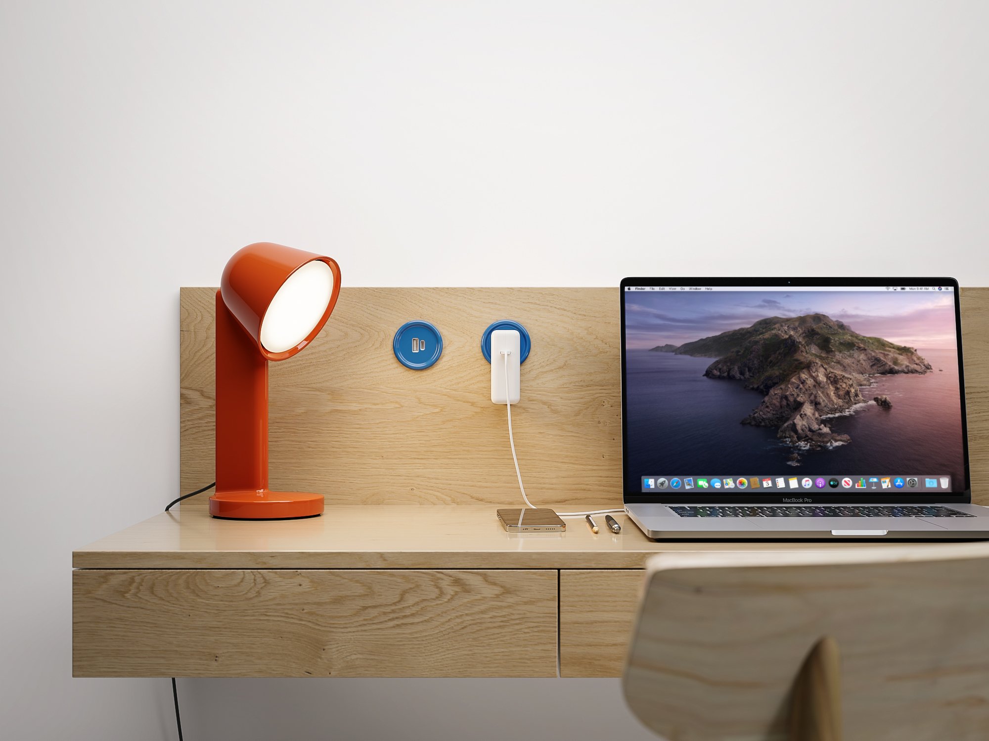 Blue Byrne Button In-Surface Outlet design on wood desk with laptop plugged in