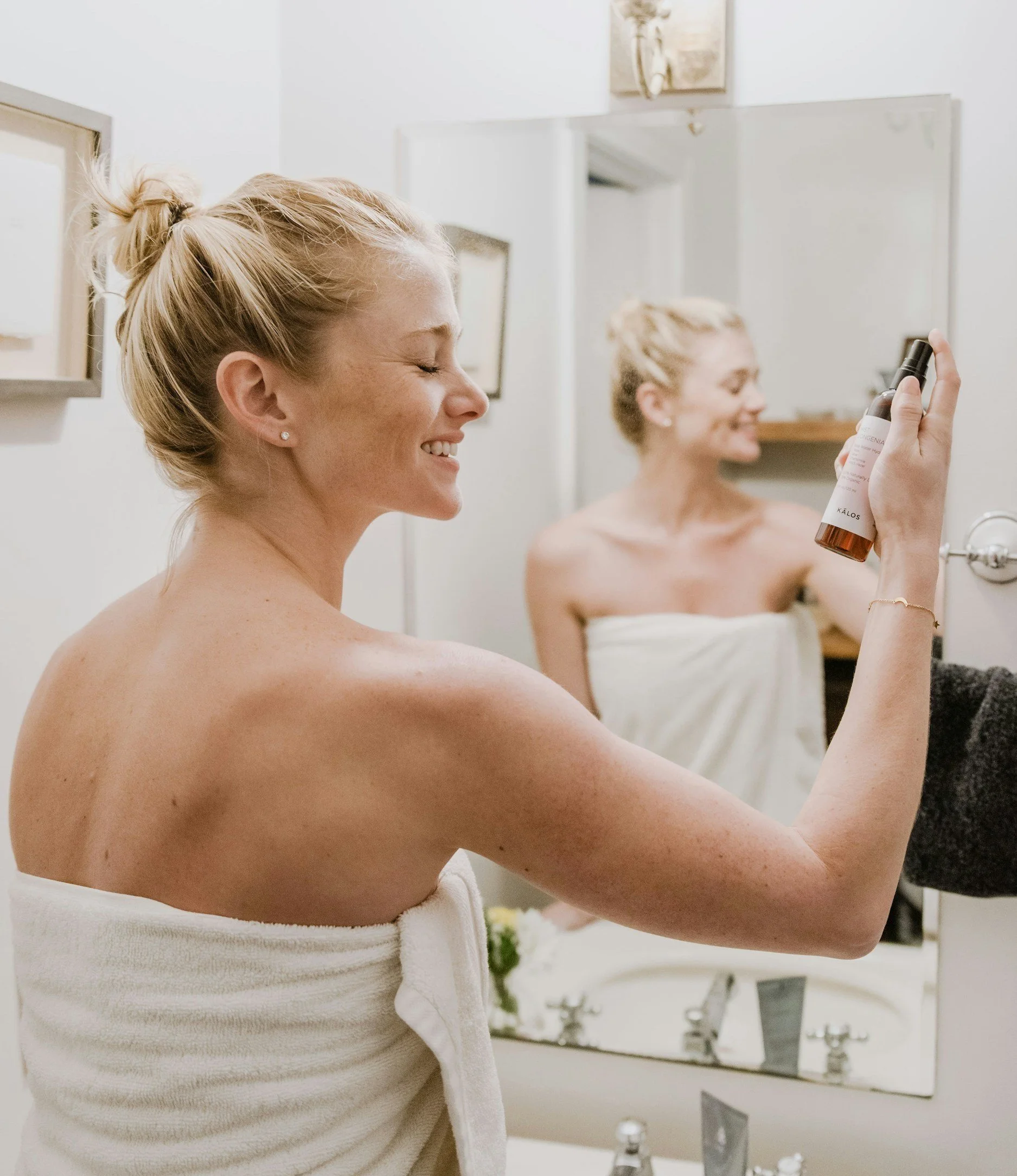 Young woman applying SPF 30 sunscreen to protect and hydrate her dry, acne-prone skin.