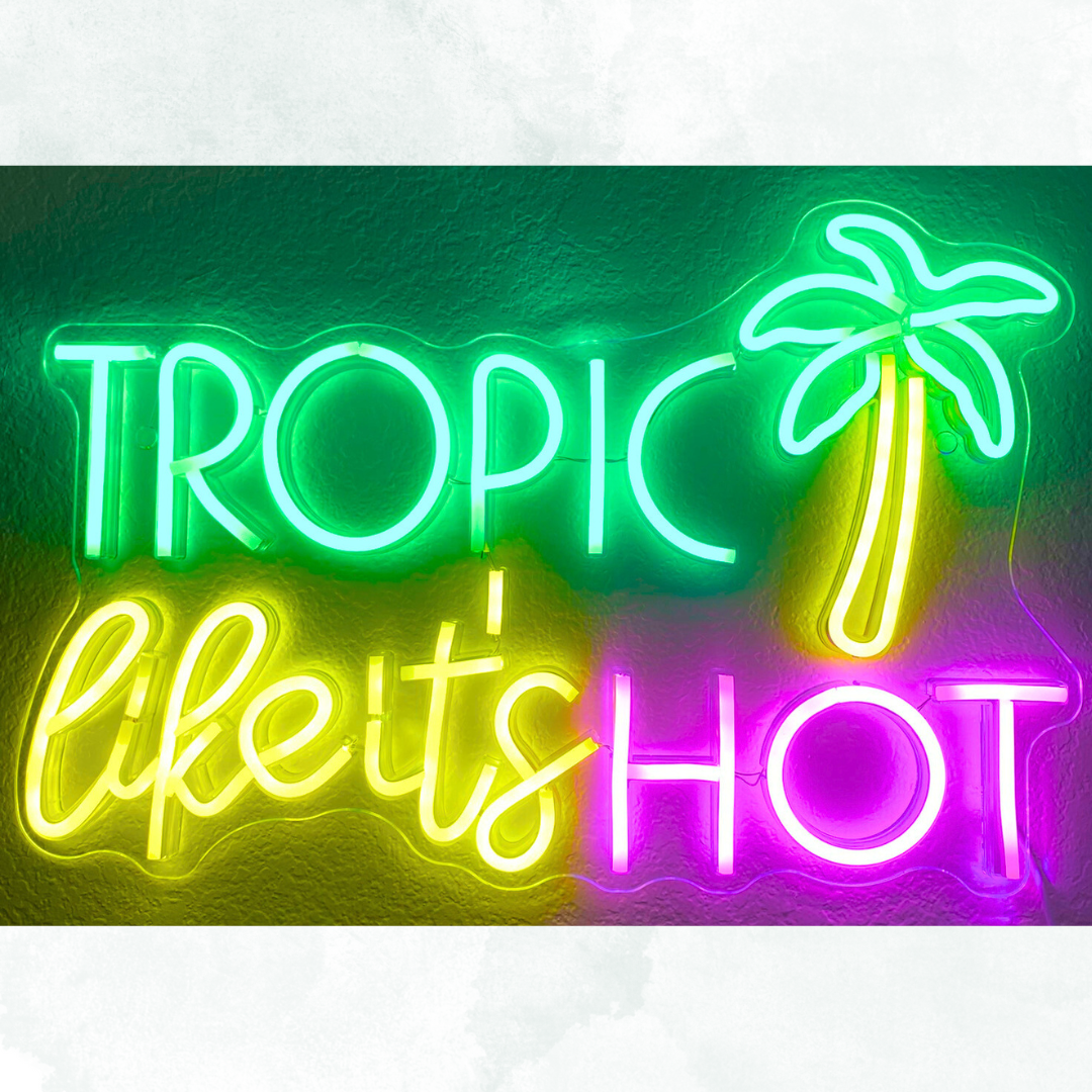 Colorful neon sign that says "Tropic Likes Hot" with a palm tree illustration.